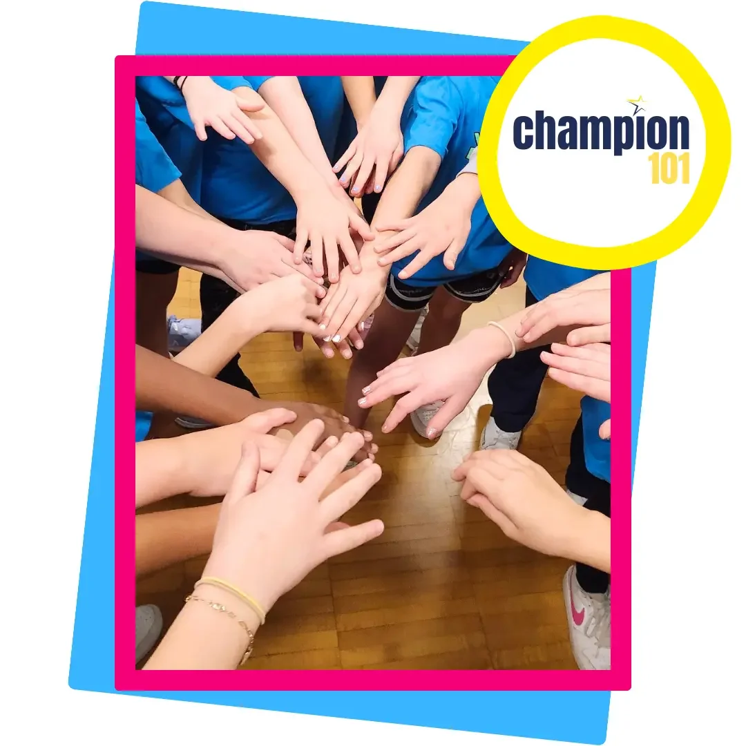 Youth participants in Champion 101 stack hands in a team huddle, symbolizing unity, leadership development, and teamwork through The Champion Project program.