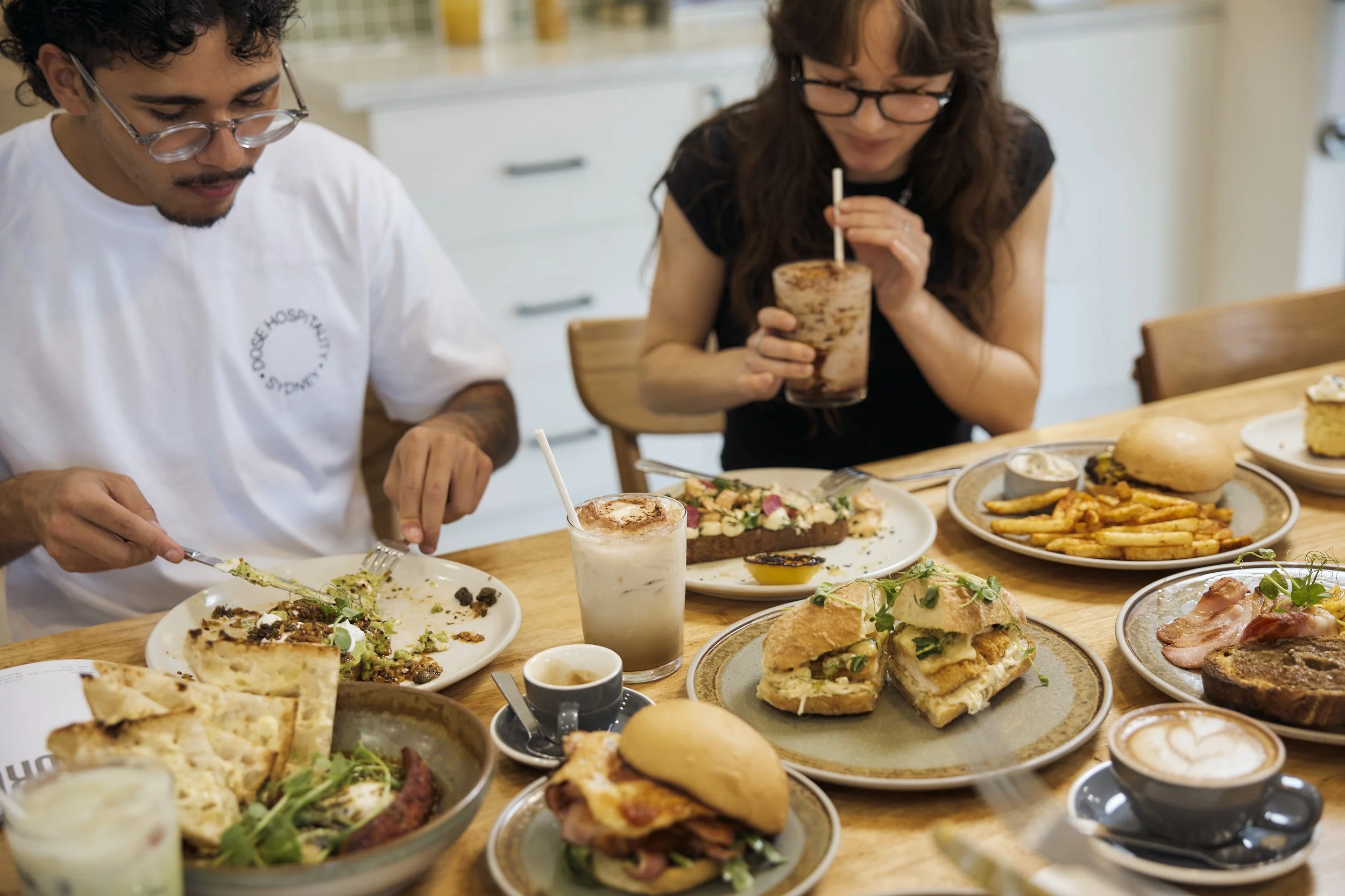 Brunch table with food and coffee at George Oyster Bay café by Dose Hospitality in southern Sydney