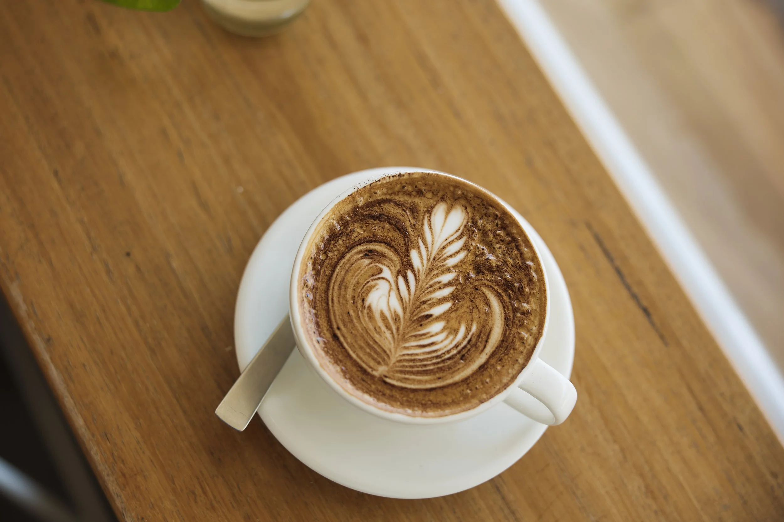 Flat white with latte art at Dose Engadine café in Sydney