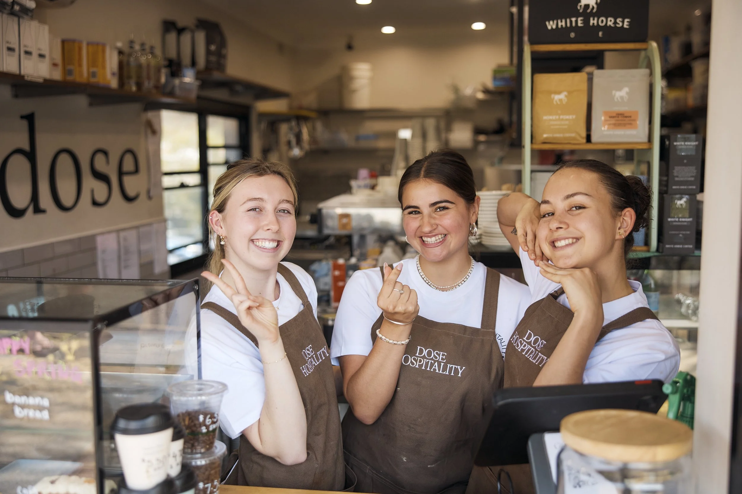Friendly staff member welcoming customers at Dose Hospitality café in Sydney