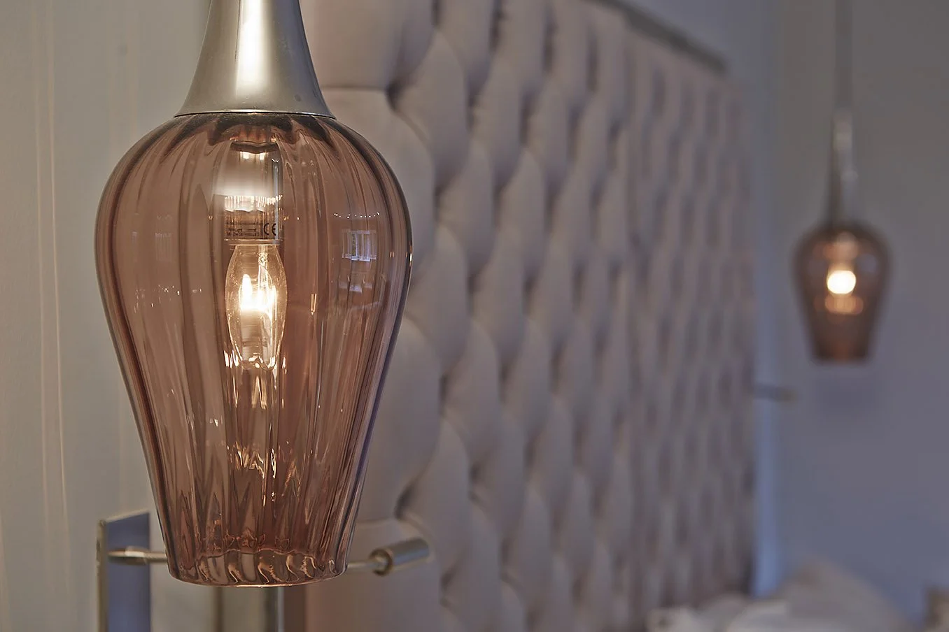 closeup of lamp detail beside the bed head 