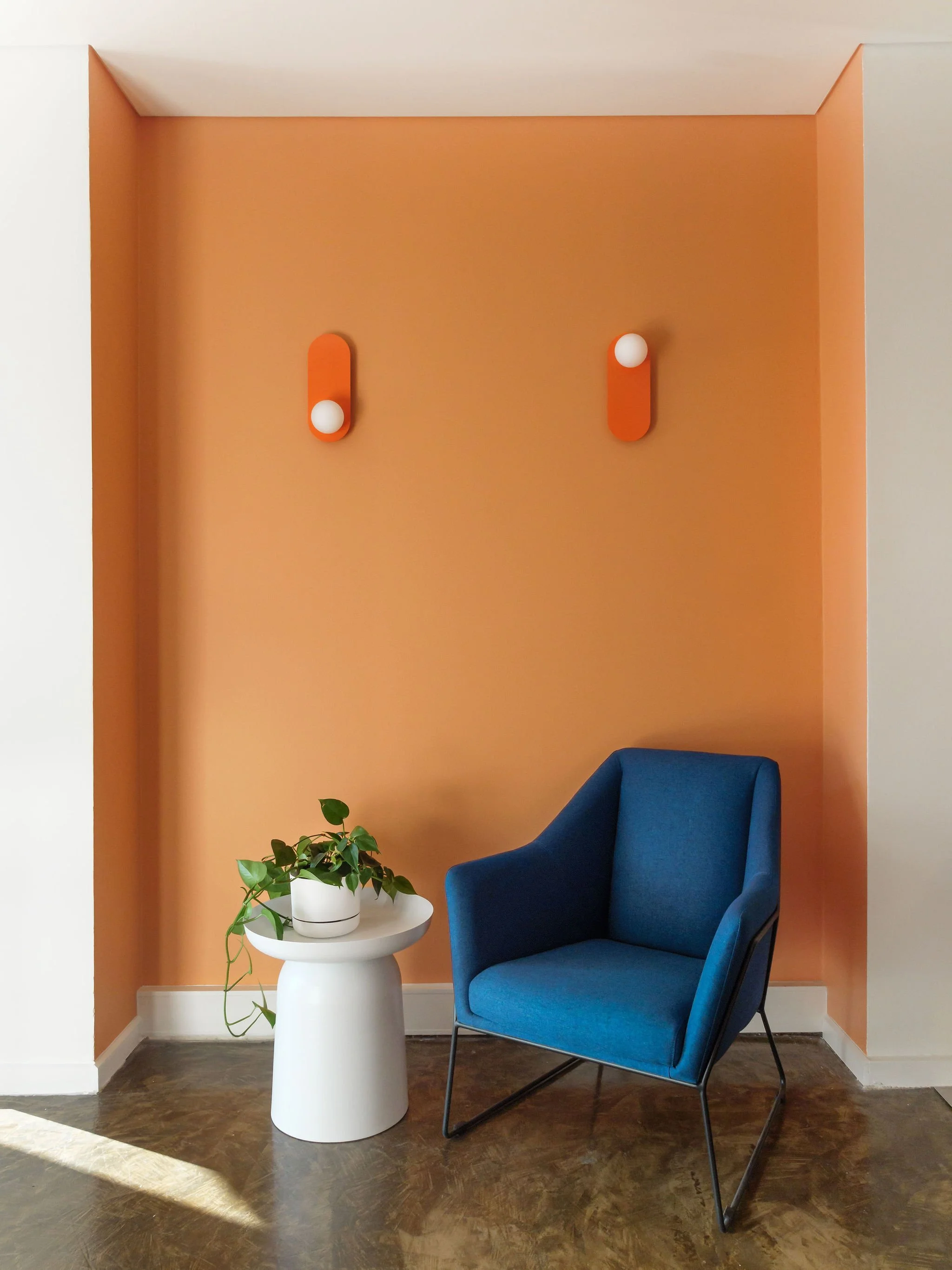 Standalone blue armchair in an alcove.