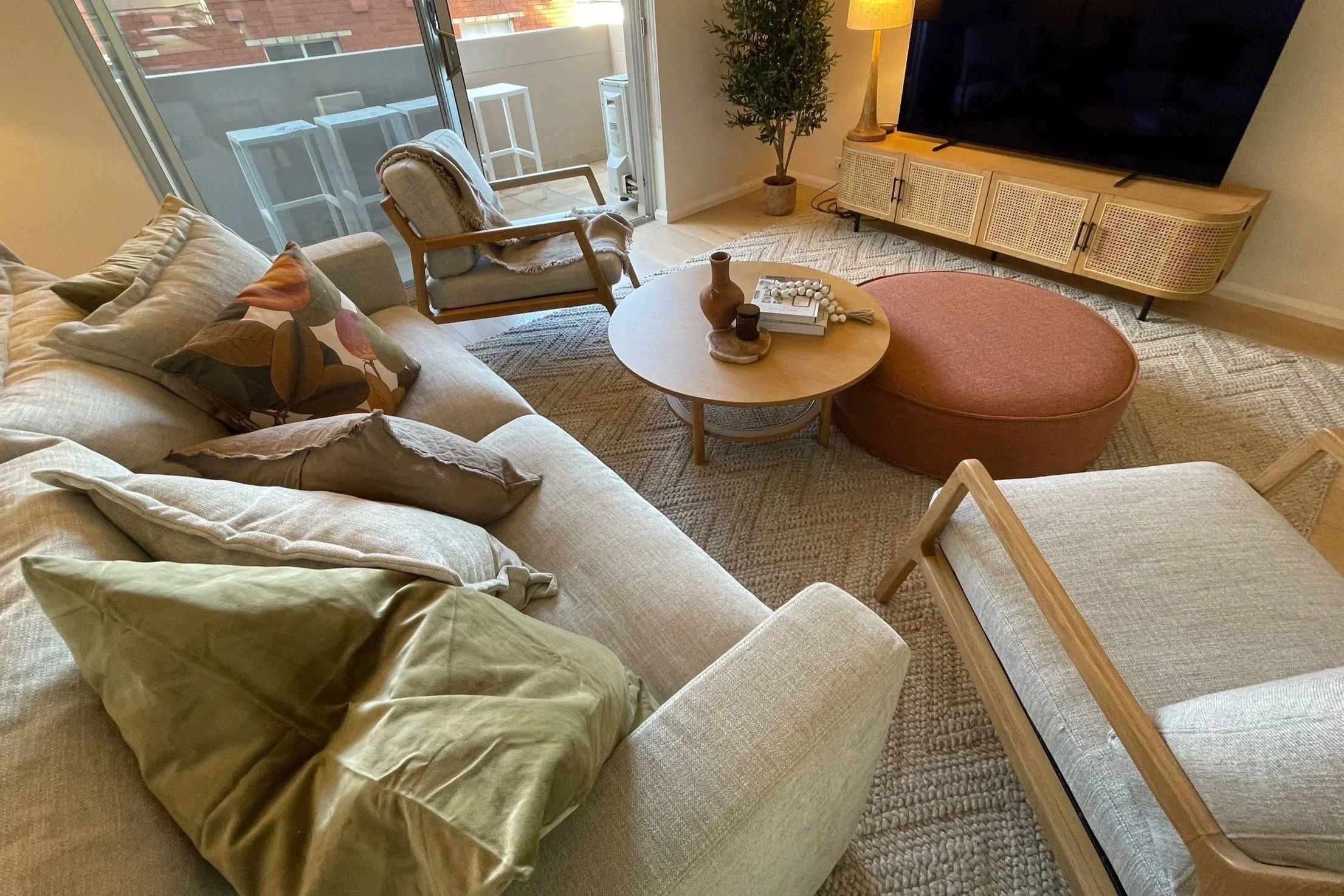 Overhead shot of full fitout beach apratment living room, warm, cozy neutral palette