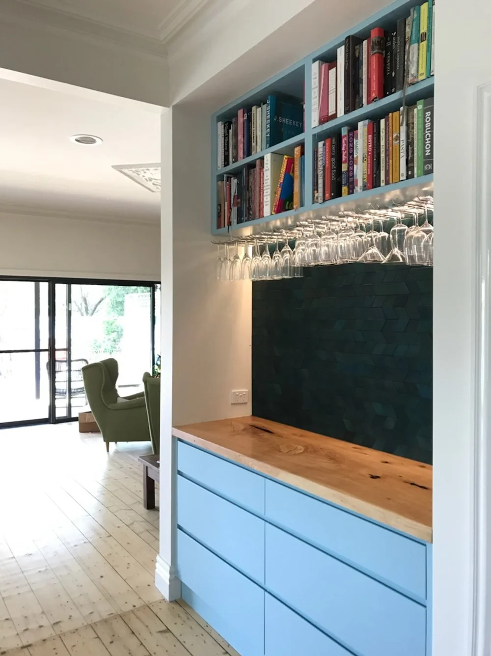 Bar and bookshelf, with view of living area in background.