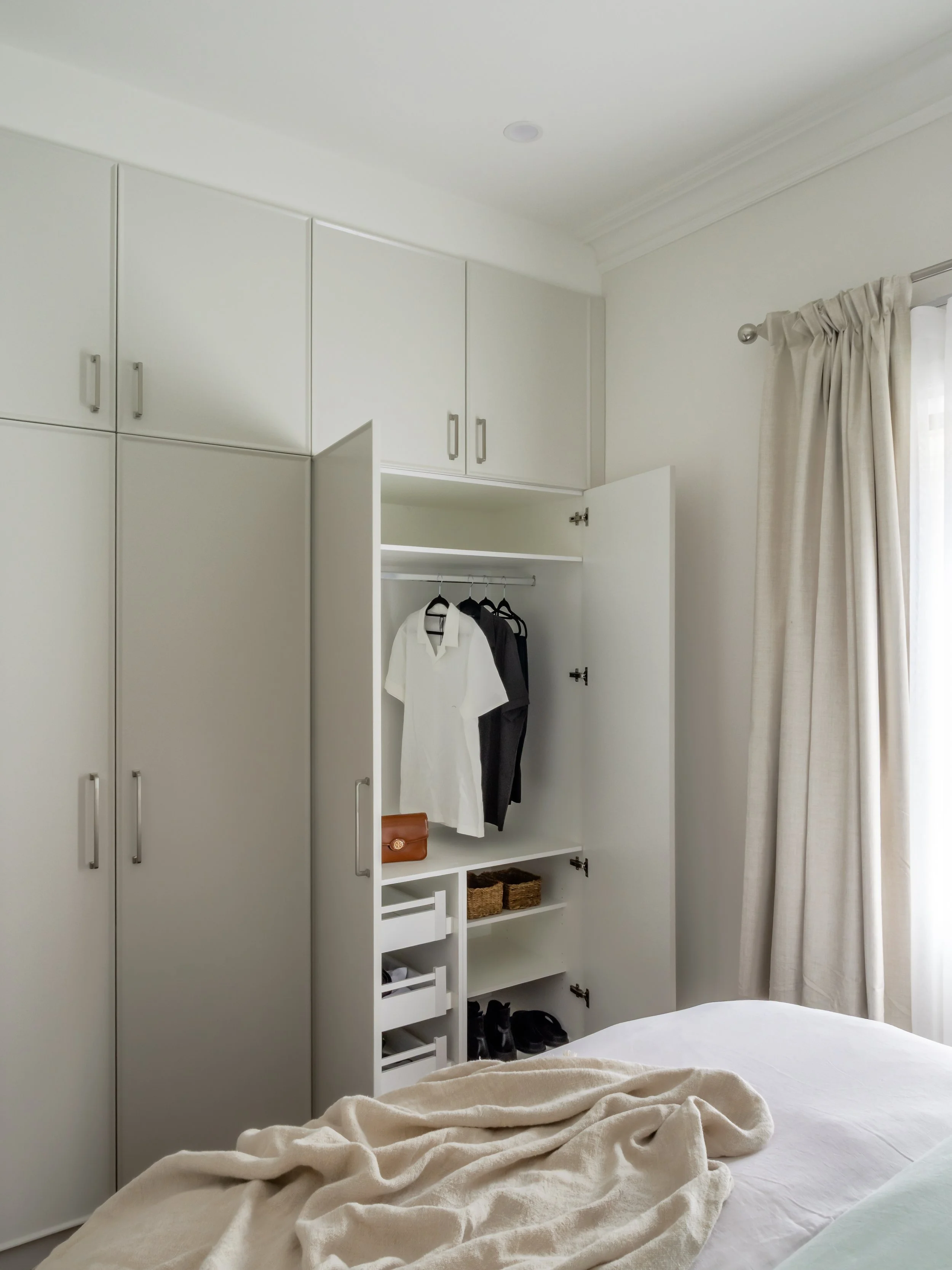 bedroom wardrobe with swing door, off-white colours, warm neutral 