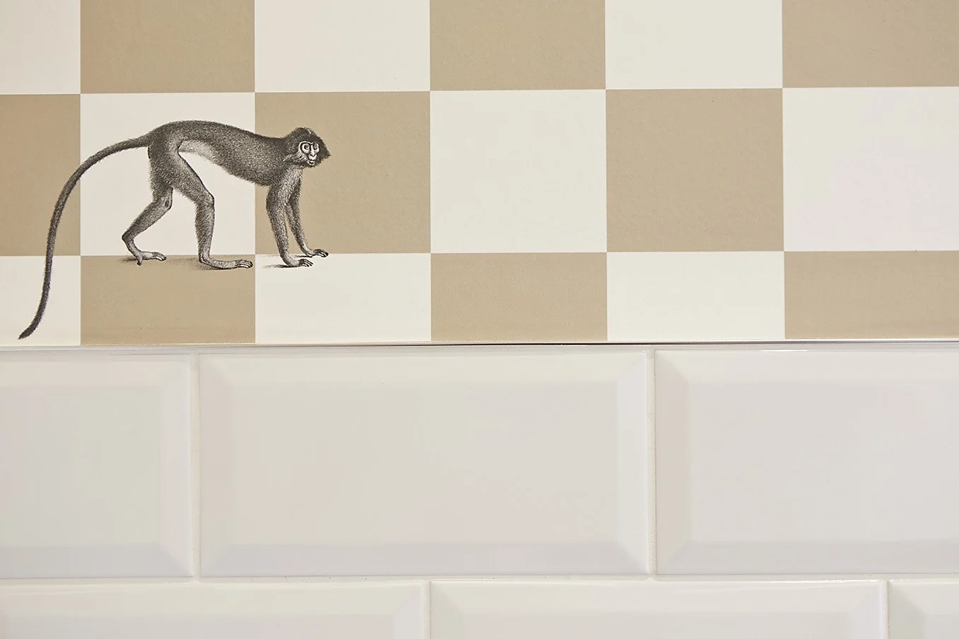 Tile pattern wall with illustrated monkey detail.