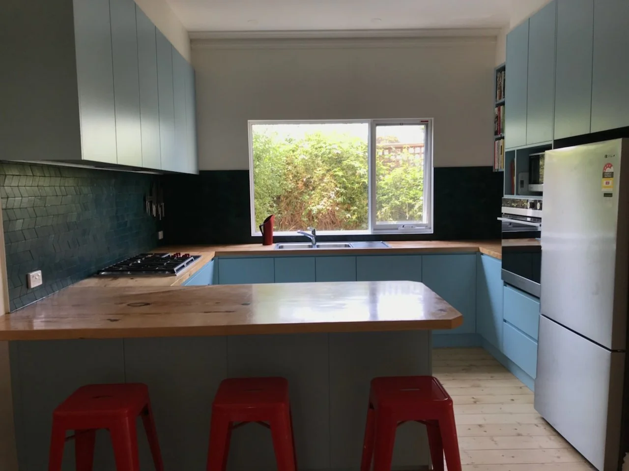 Inviting and practical kitchen interior design, making use of the natural light from the window.