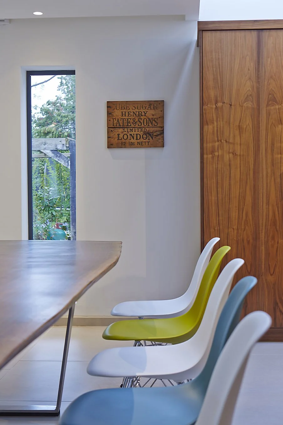 tight view of dining area, showcasing bold, contemporary dining chairs and wooden furniture 