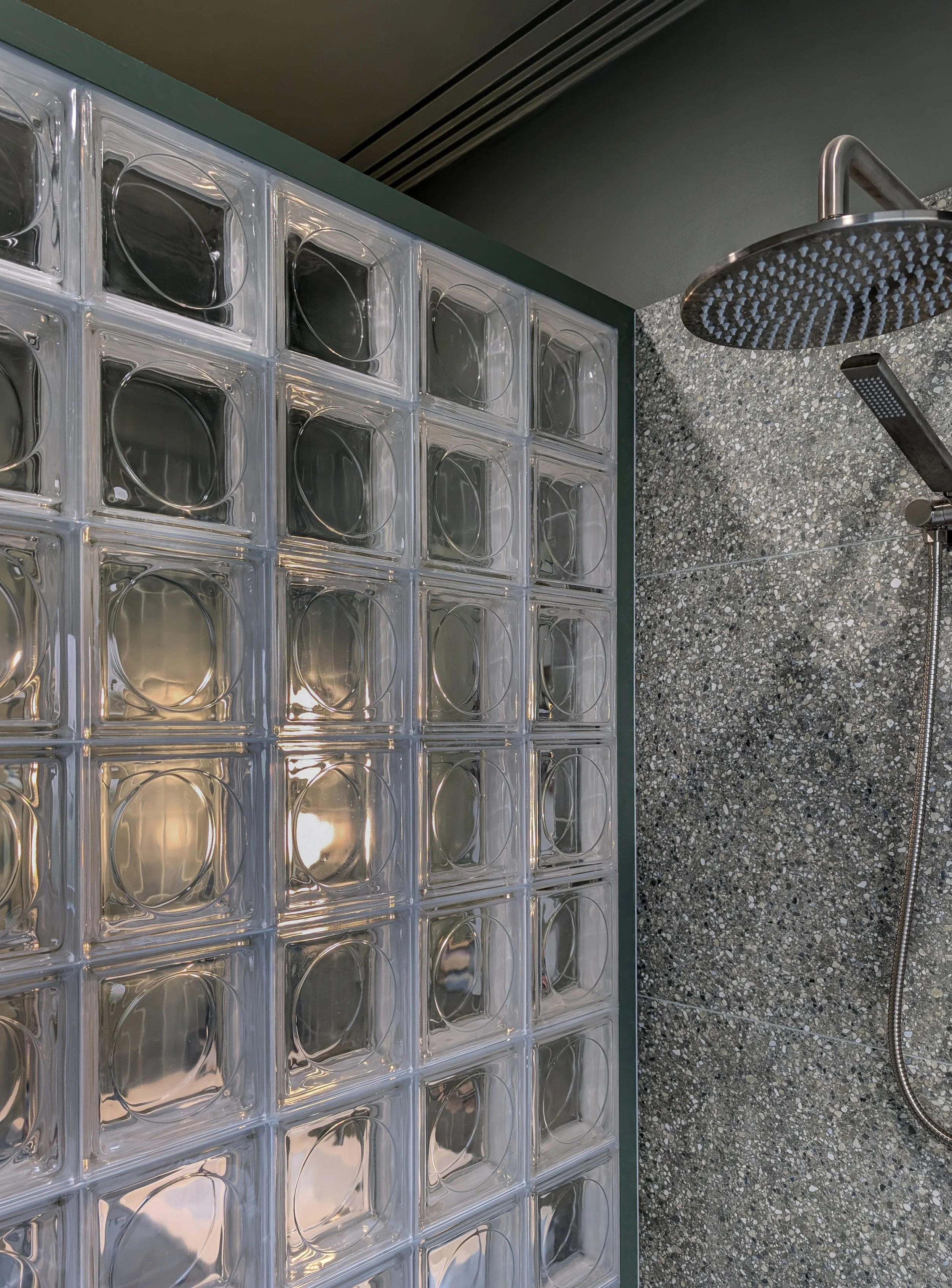 view of the glass square wall, and shower head for the renovated bathroom 