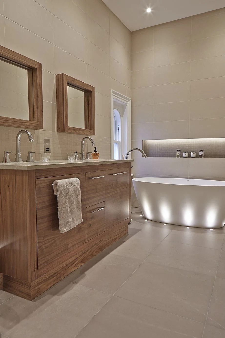 Bathroom with wooden and pale ceramic details 