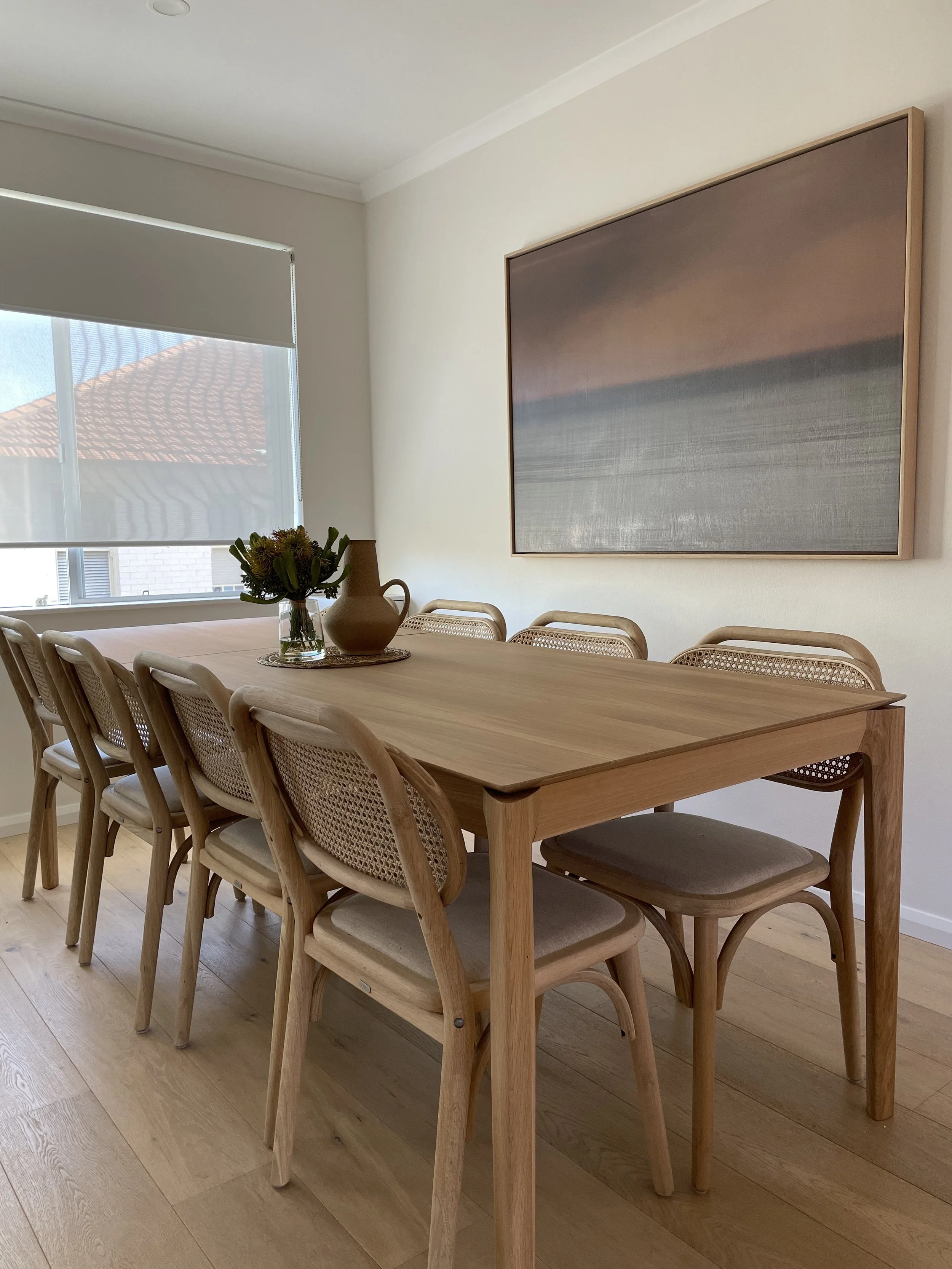 zoomed out view of the dining area. the wooden furniture invokes a sustainable feel.