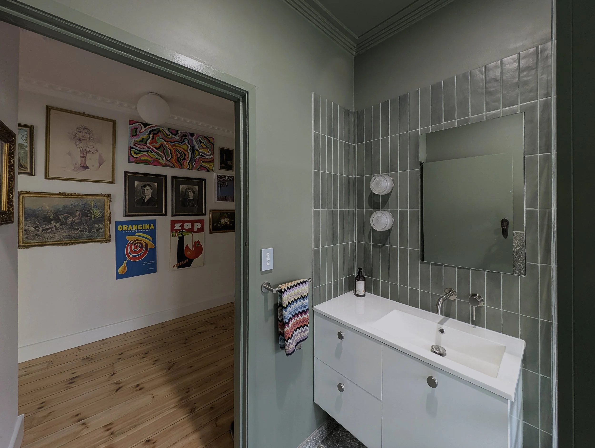Interior design for bathroom in Brunswick house, soft sage green walls, modern fixtures.