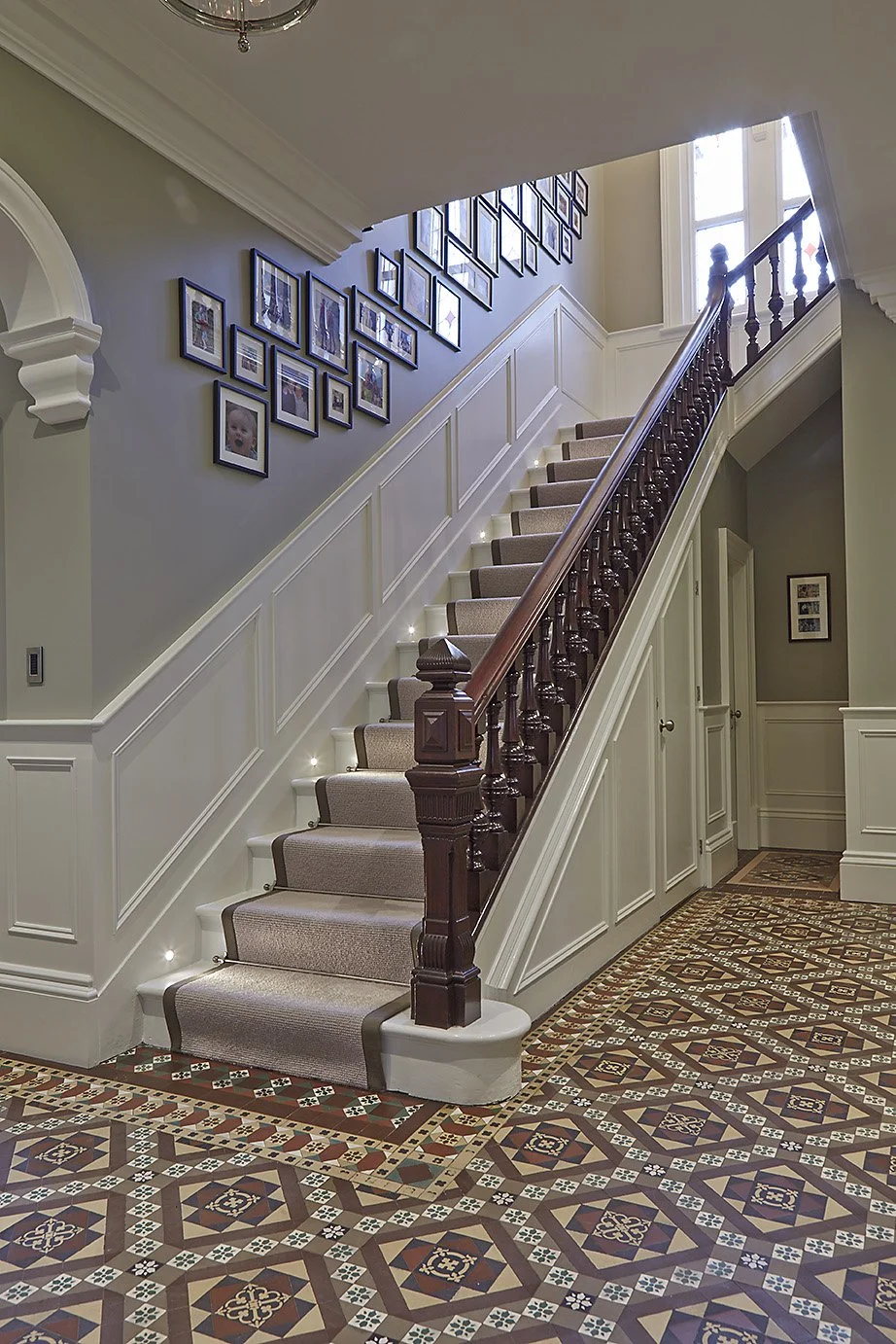 Wide shot of staircase with carpet detail, soft natural hues, and tiled floor