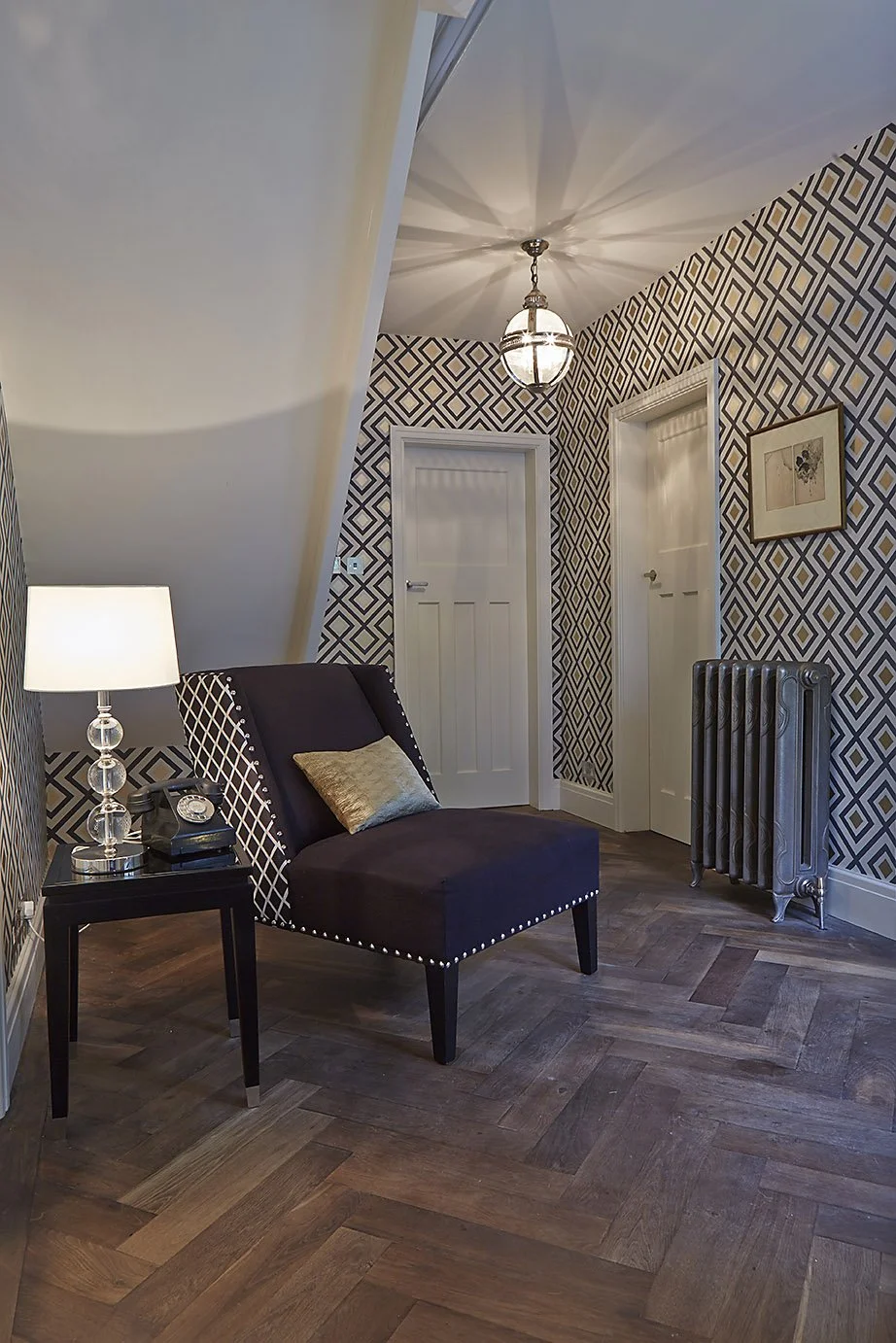 hallway area showing herringbone floor and metal wall heater