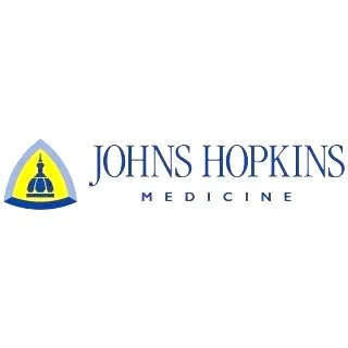 The Johns Hopkins Medicine logo featuring a yellow and blue emblem with a building silhouette and the text 'JOHNS HOPKINS MEDICINE'.