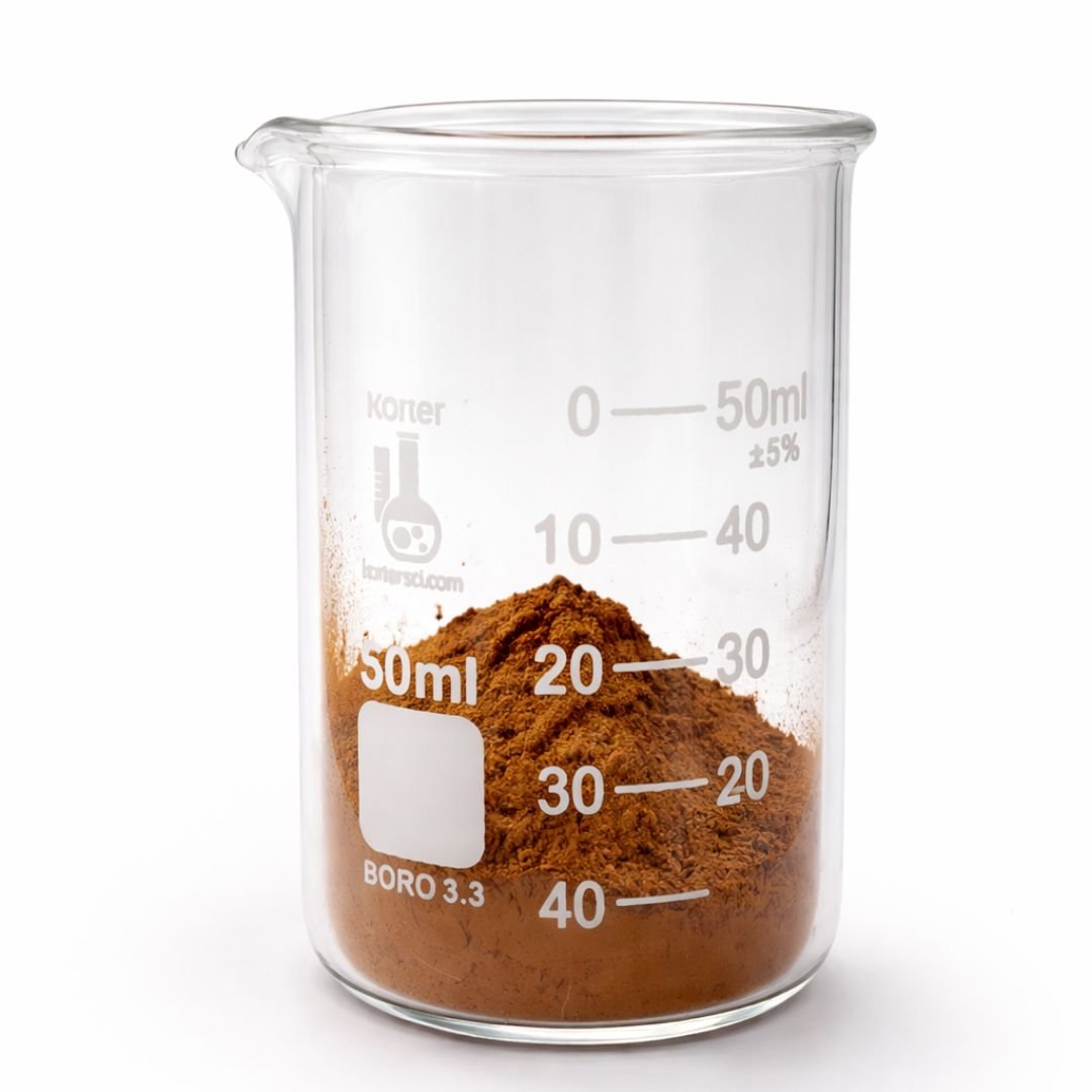 A glass beaker filled with mineral makeup, marked with measurement lines from 0 to 50 milliliters.