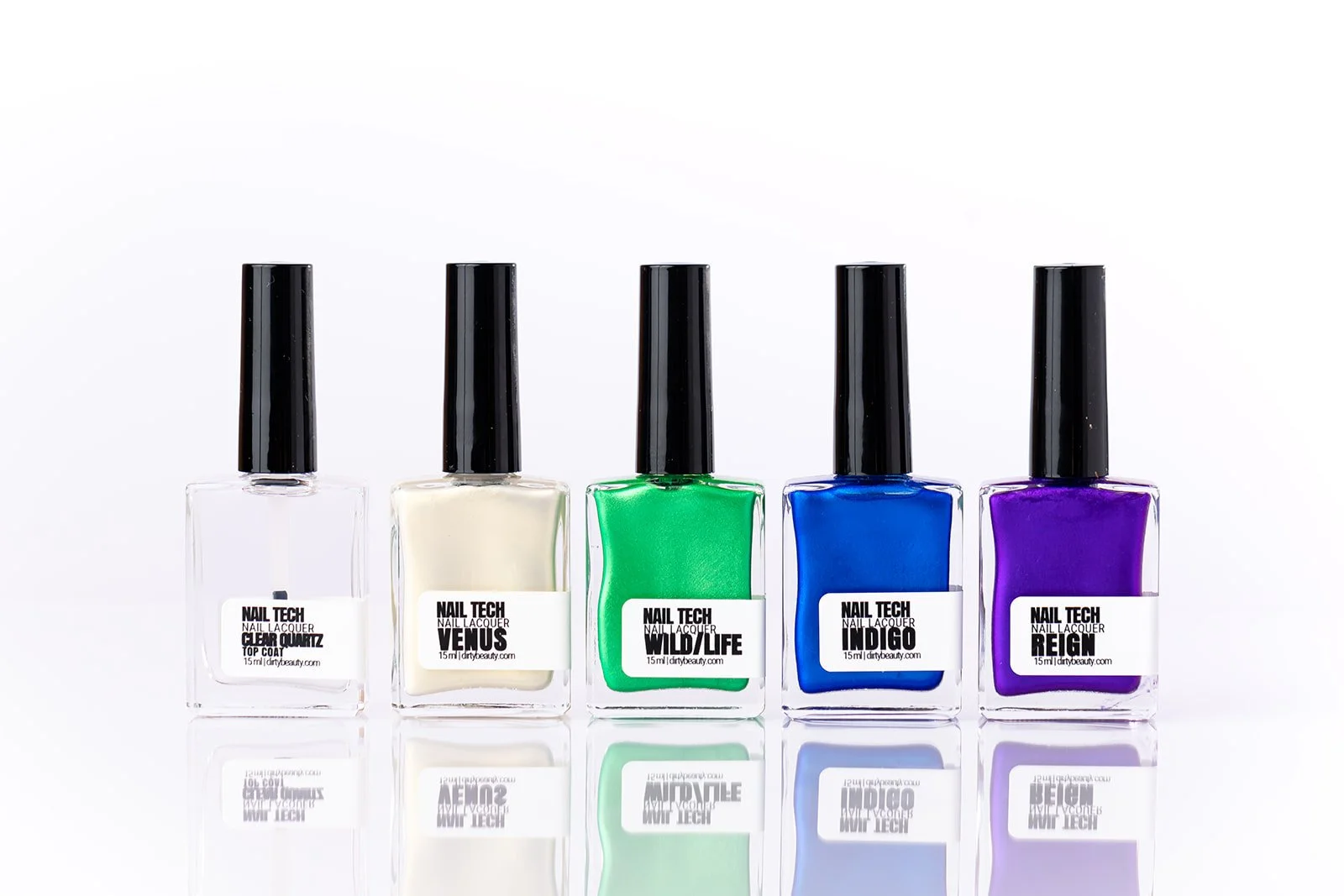 Five bottles of nail polish in clear, white, green, blue, and purple colors, lined up on a reflective surface against a white background.