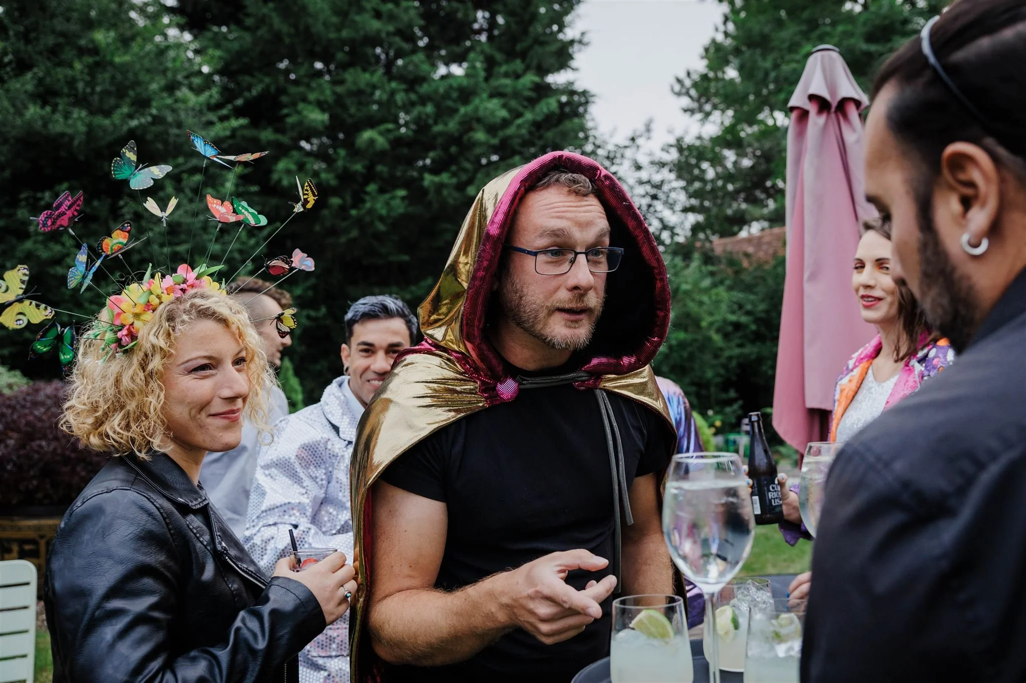 Eclectic group of guests enjoy drinks at a summer party