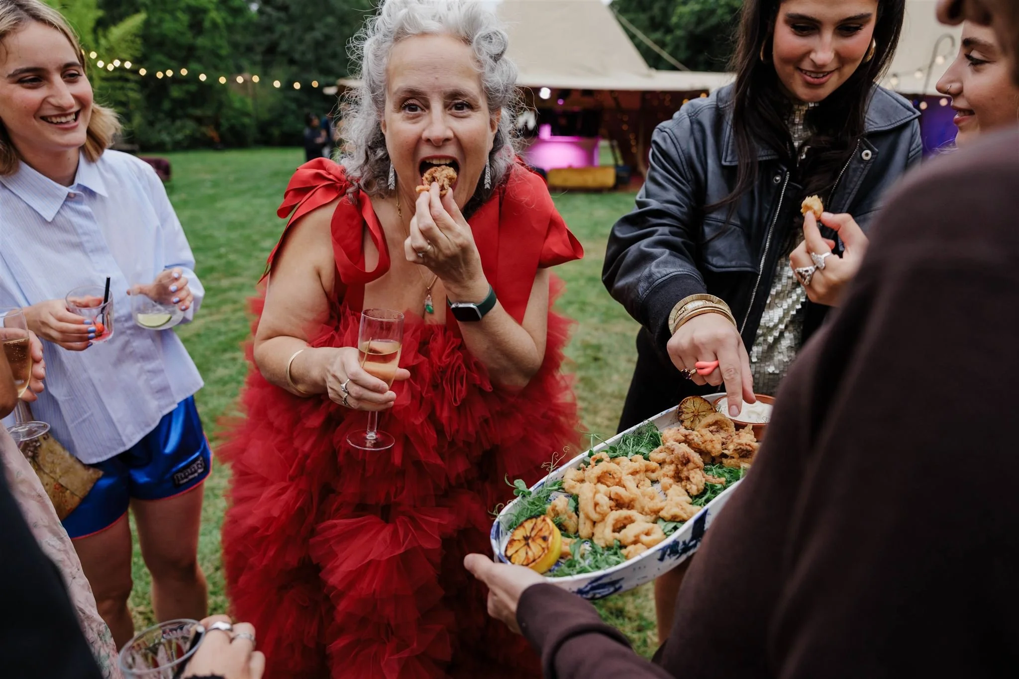 Guests enjoy canapes at a summer garden party