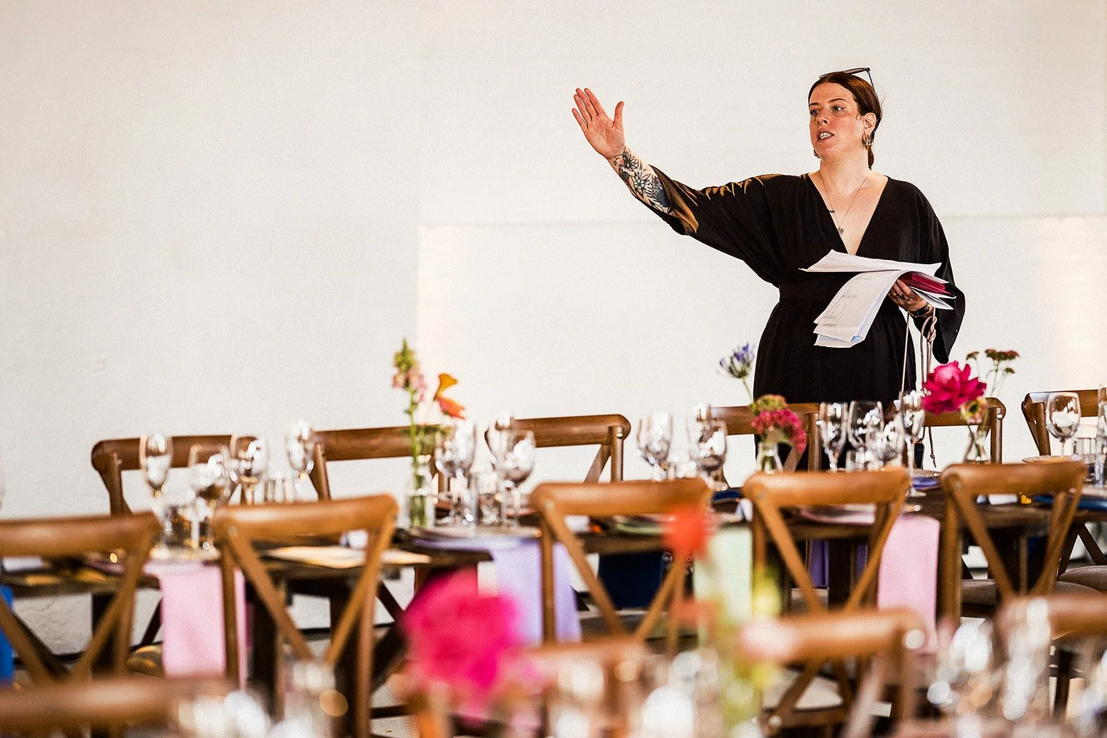 A cool looking event manager directs a dinner set up