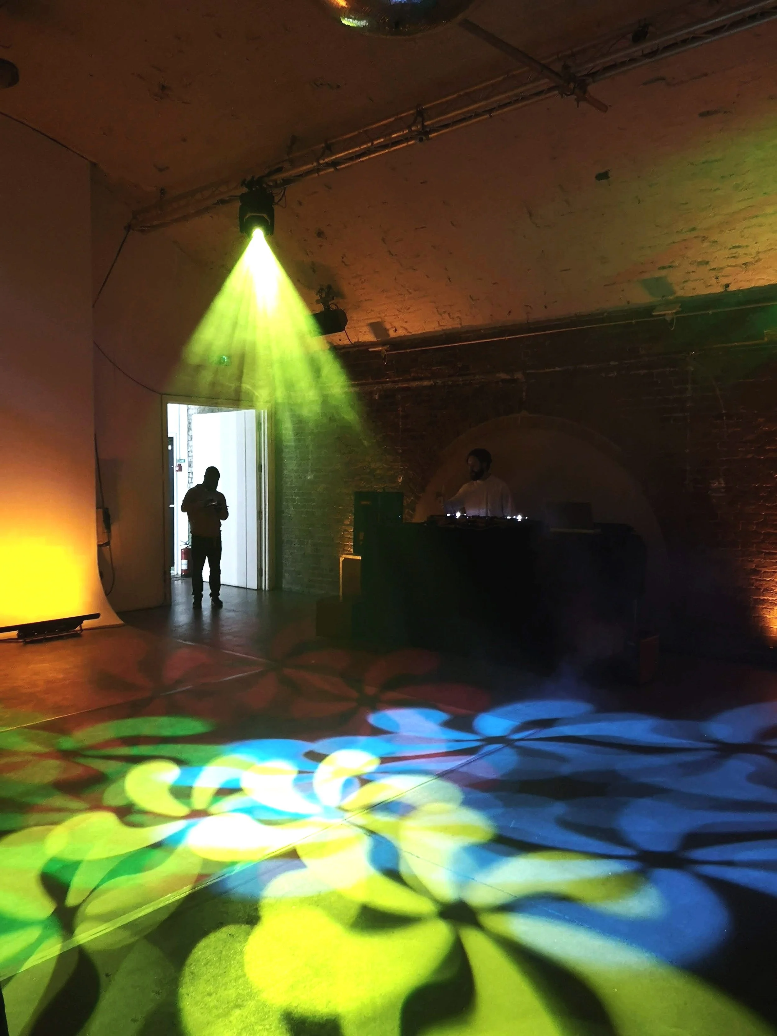 Cool dancefloor lights being checked at an industrial style venue