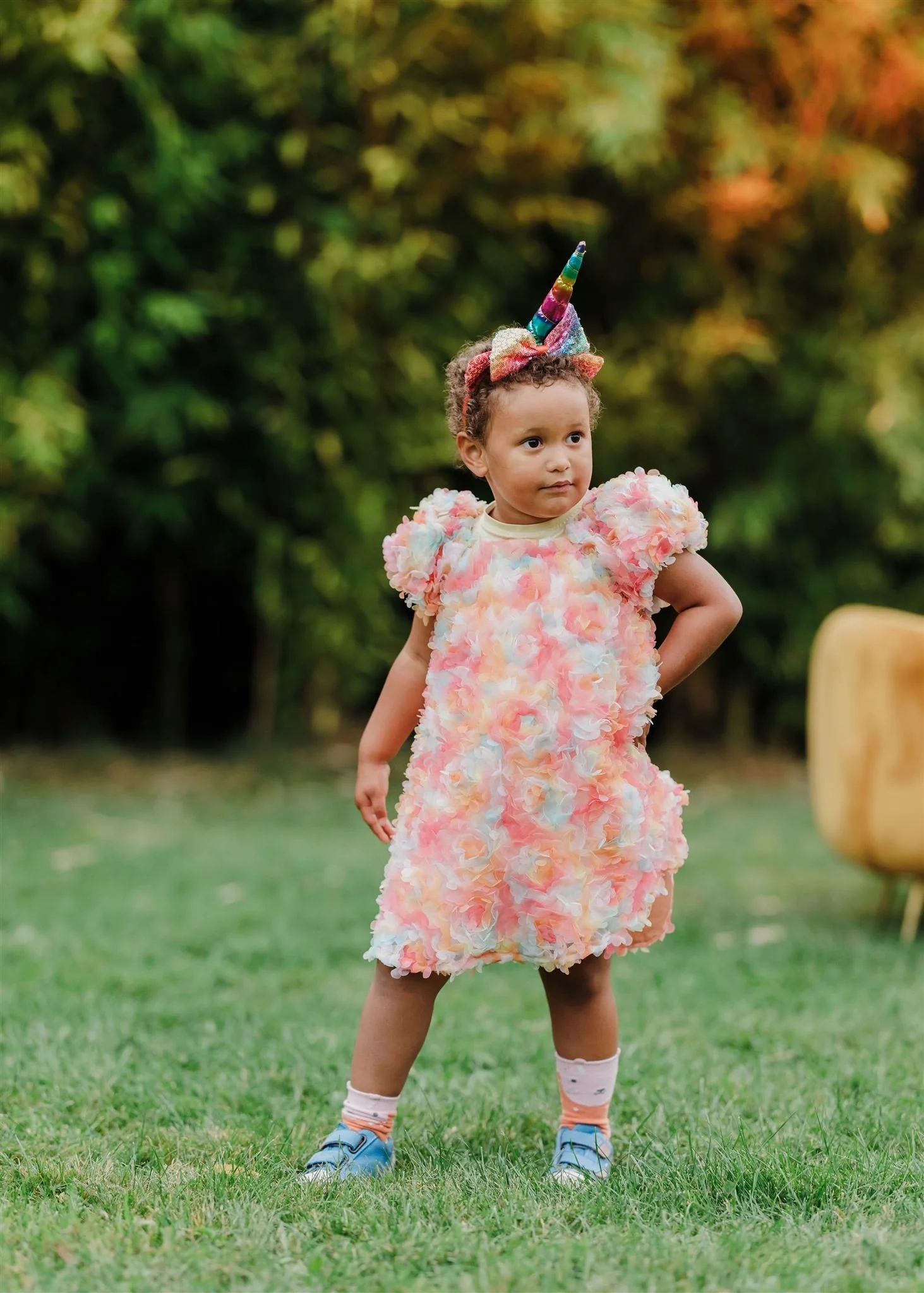 A young girl in a pink dress enjoys a fun summer party