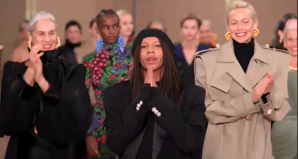 Finale moment from a Balmain runway show, with models applauding on the catwalk.”