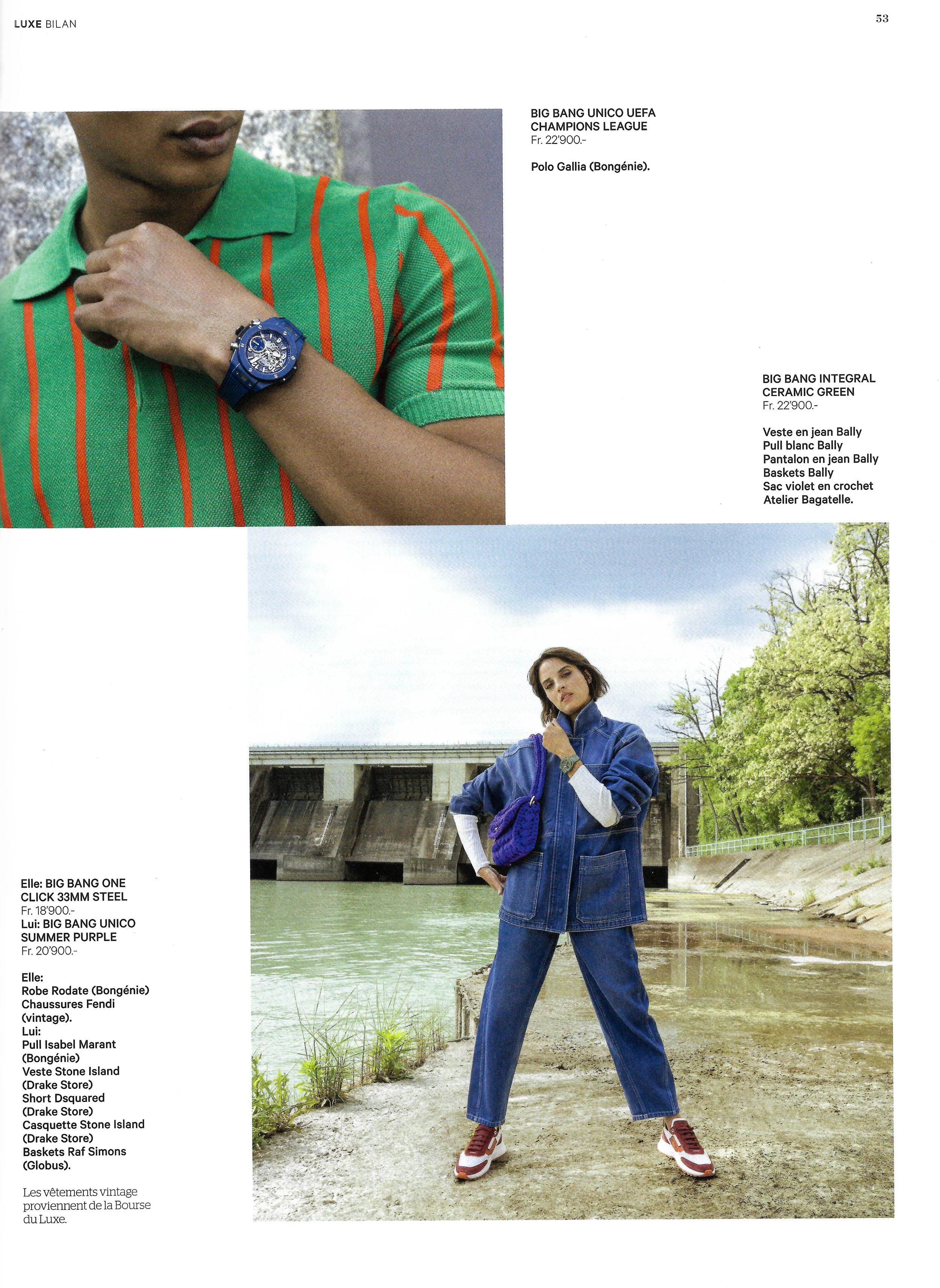 Fashion magazine page featuring two models, one wearing a green and orange striped polo shirt with a blue wristwatch, and the other in a denim jacket and pants with a purple bag, standing outdoors near a river with trees in the background.