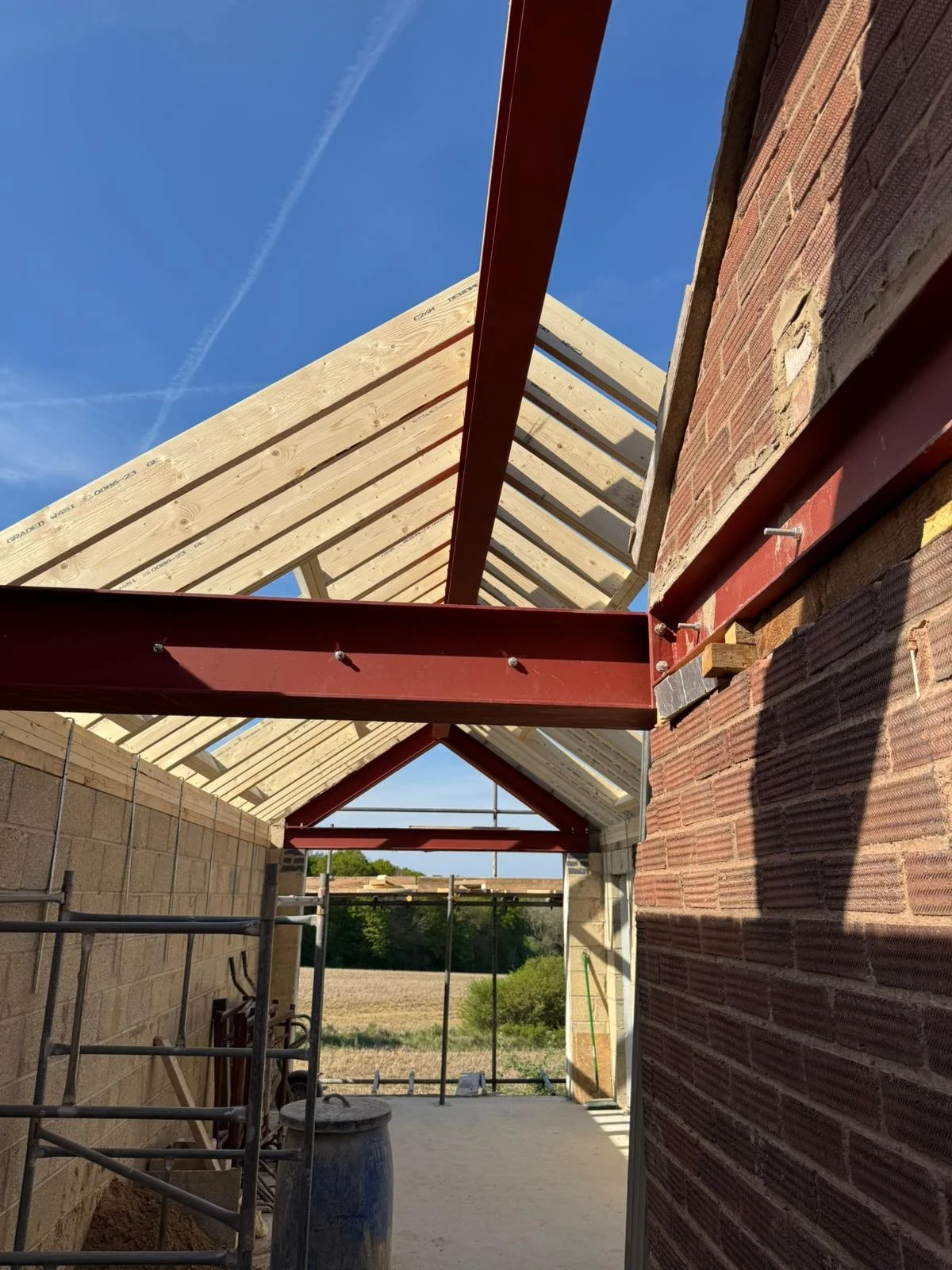 Steel beams supporting a new timber roof on a house extension