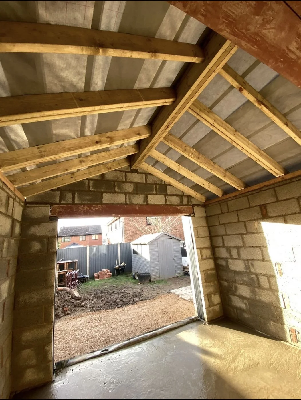 Steel ridge beam and loose timber rafters forming a vaulted extension roof, Ashbourne