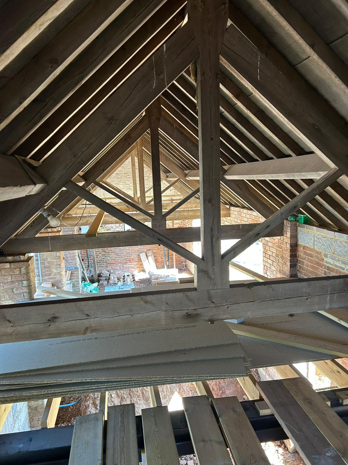 Existing timber roof trusses in a barn conversion during structural works