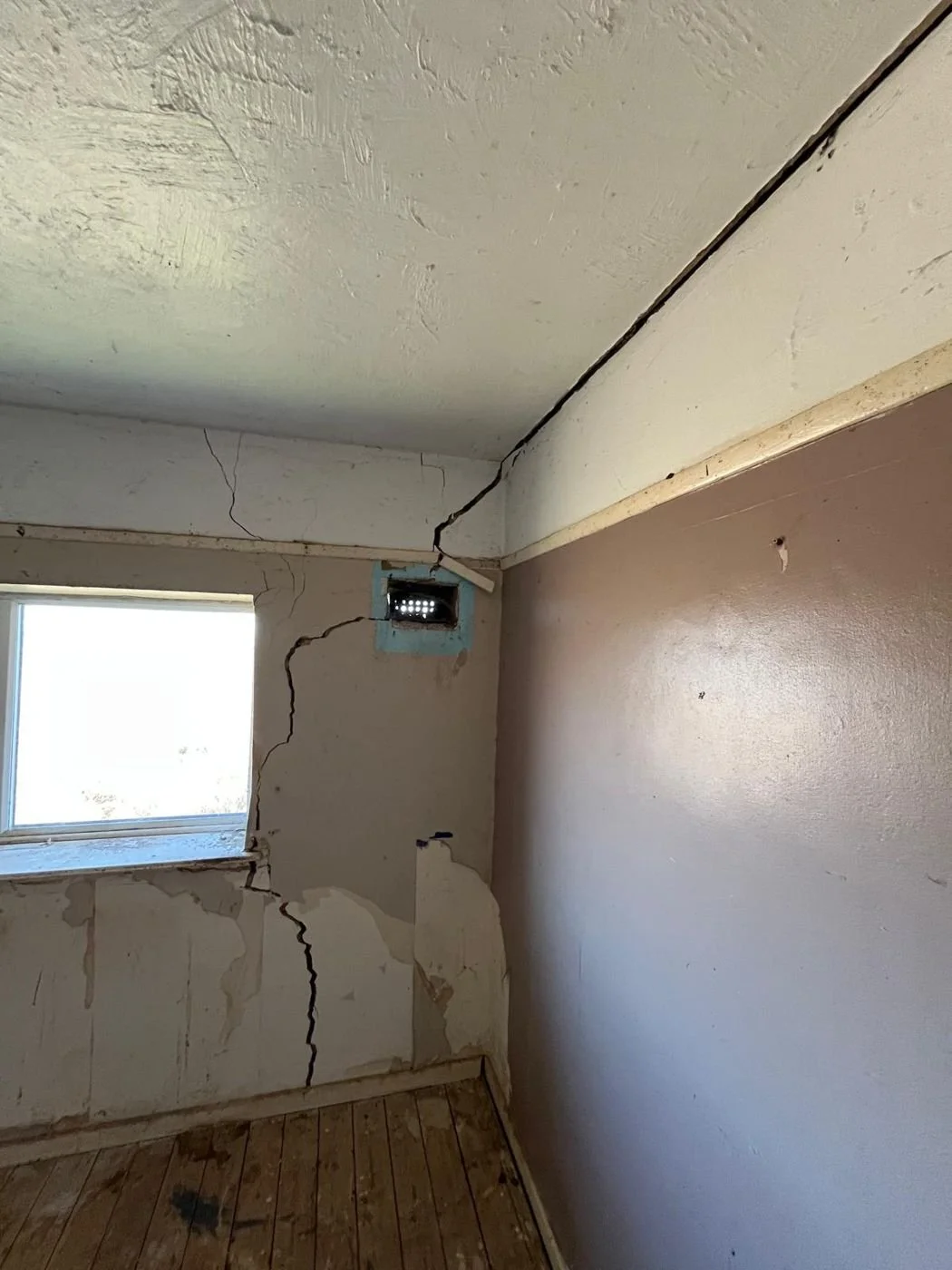 Subsidence cracking at the wall and ceiling junction of a 1970s house, Stone