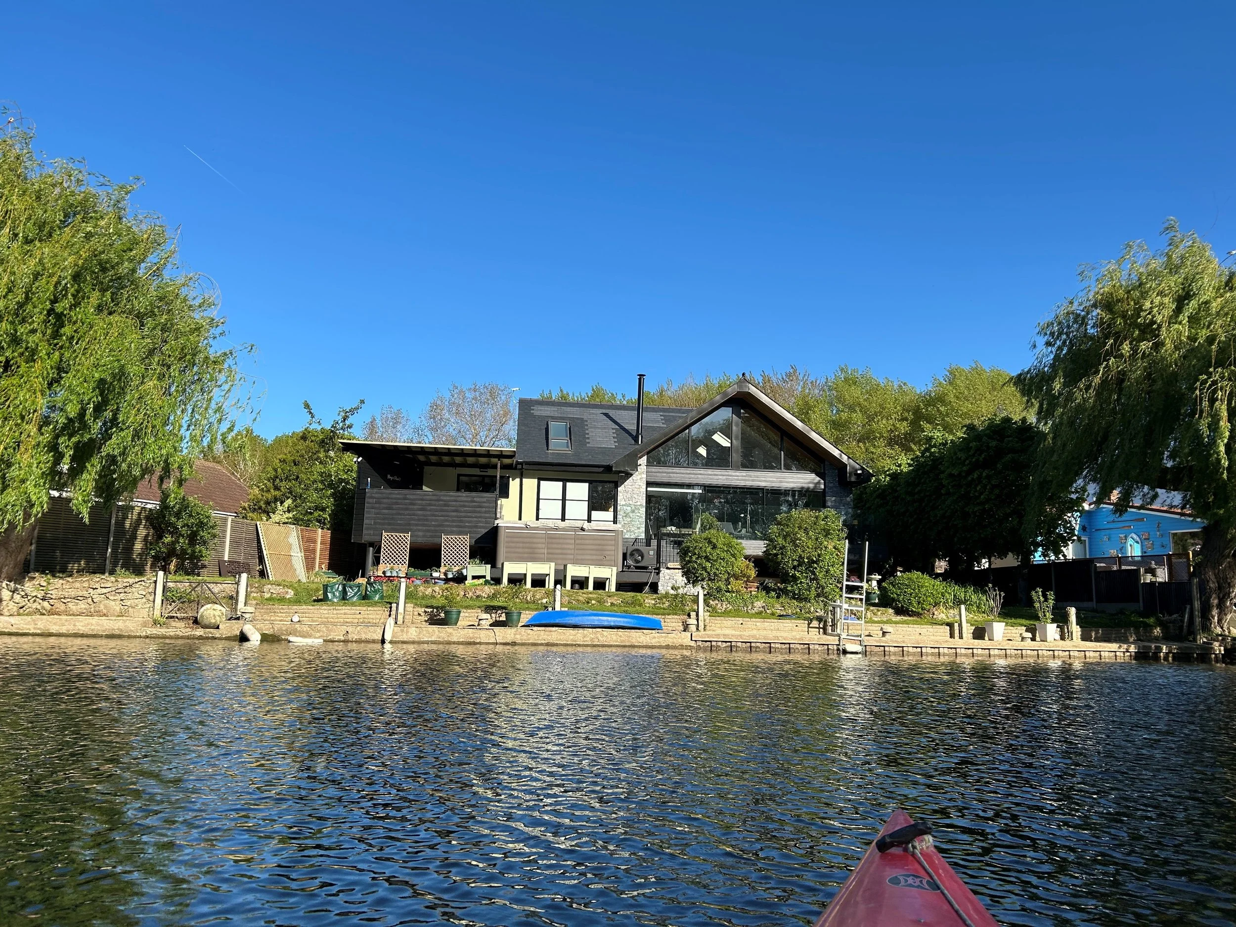 Completed riverside house on piled foundations, seen from the River Thames, Shepperton