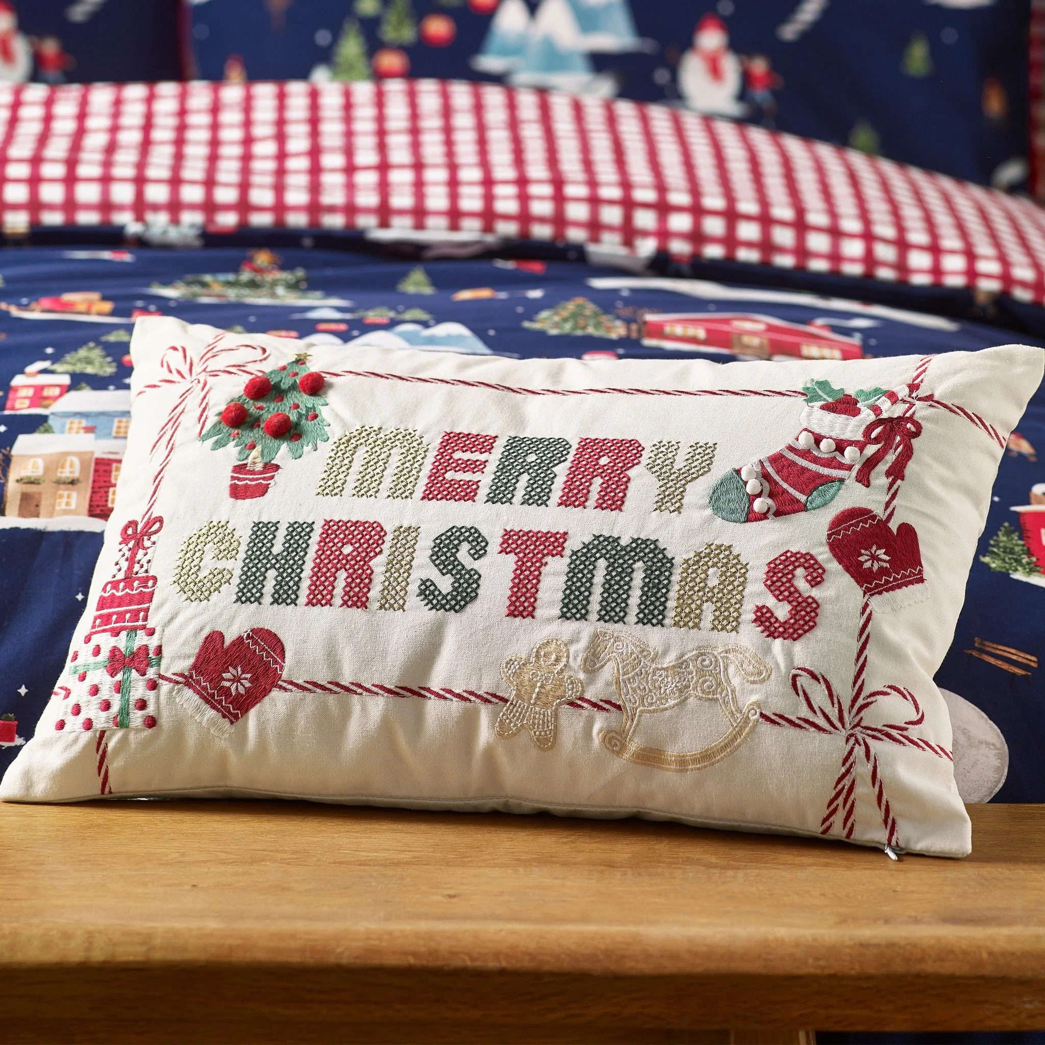Add a timeless festive touch to your home 🎄✨

This beautifully crafted cushion features a charming cross stitch style design with classic Christmas details and a cheerful &ldquo;Merry Christmas&rdquo; message, perfect for cosy sofas, armchairs, or b