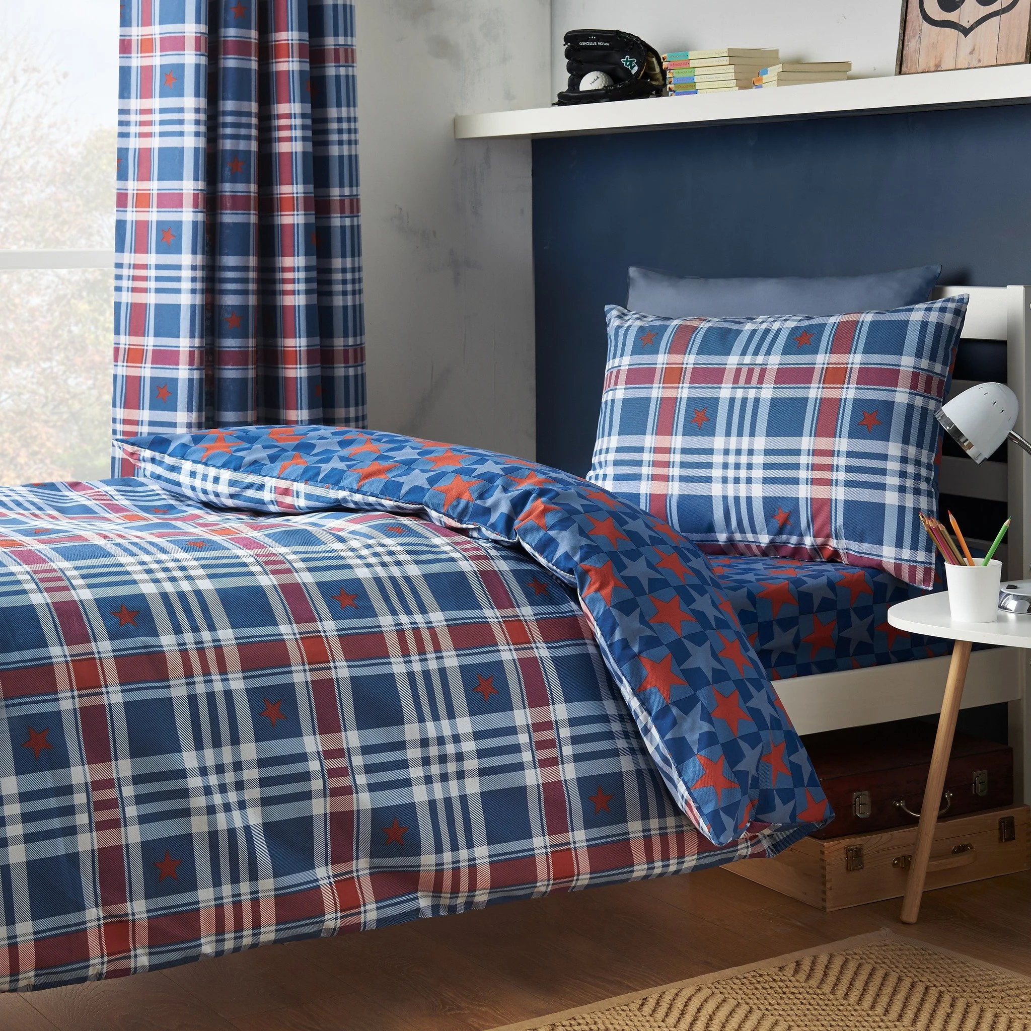 Bring a bold twist to bedtime ⭐

Classic checks in deep navy and brick red are scattered with playful stars, blending timeless pattern with a fun, adventurous edge. Fully reversible for two looks in one, it&rsquo;s everyday comfort with standout styl