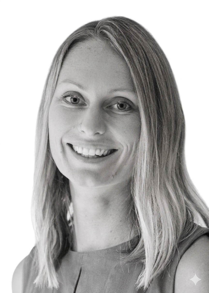 Black and white portrait of Dr Michaelia with shoulder-length hair, wearing a sleeveless top.