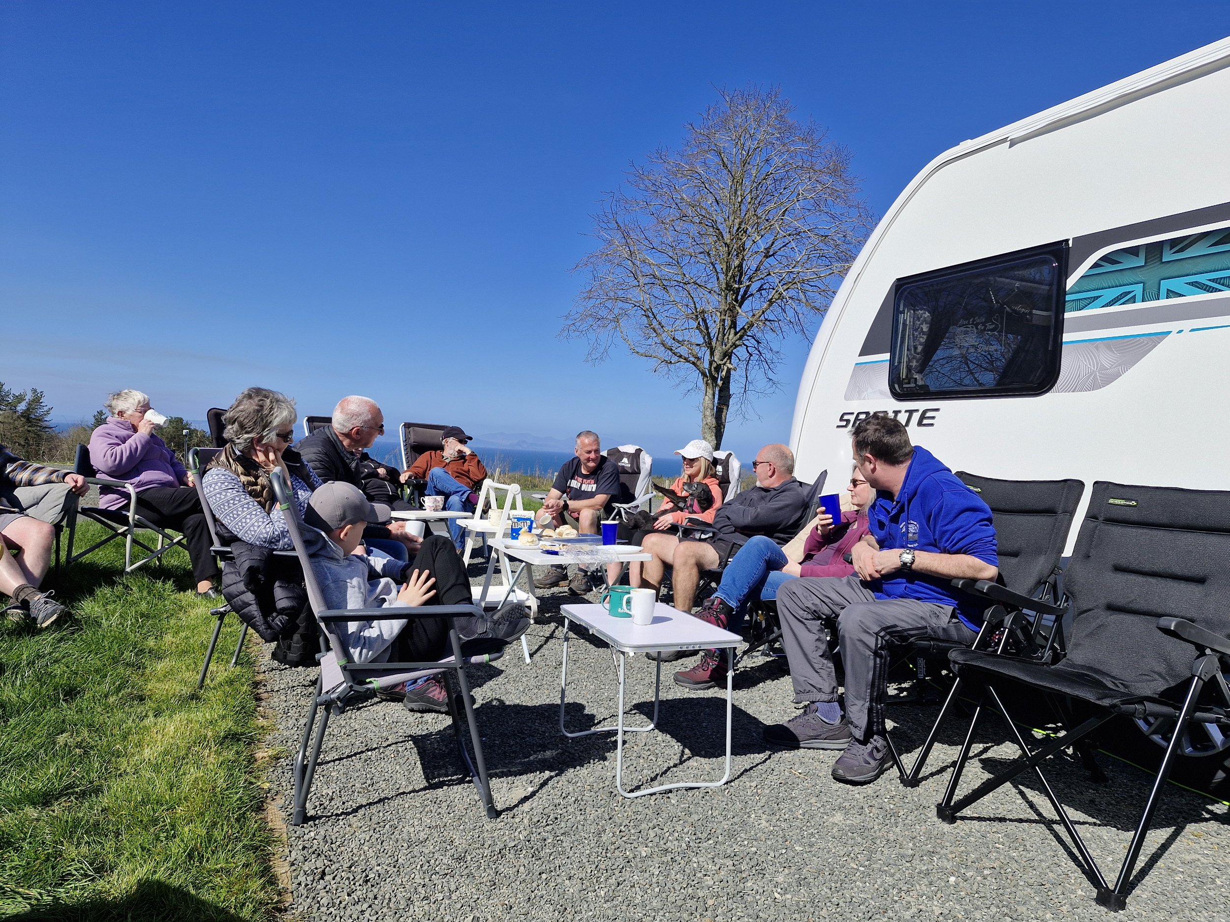 people in group outside caravan