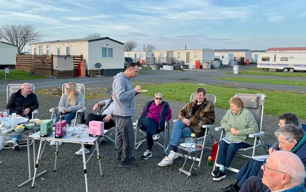 People enjoying cheese & wine in caravan park