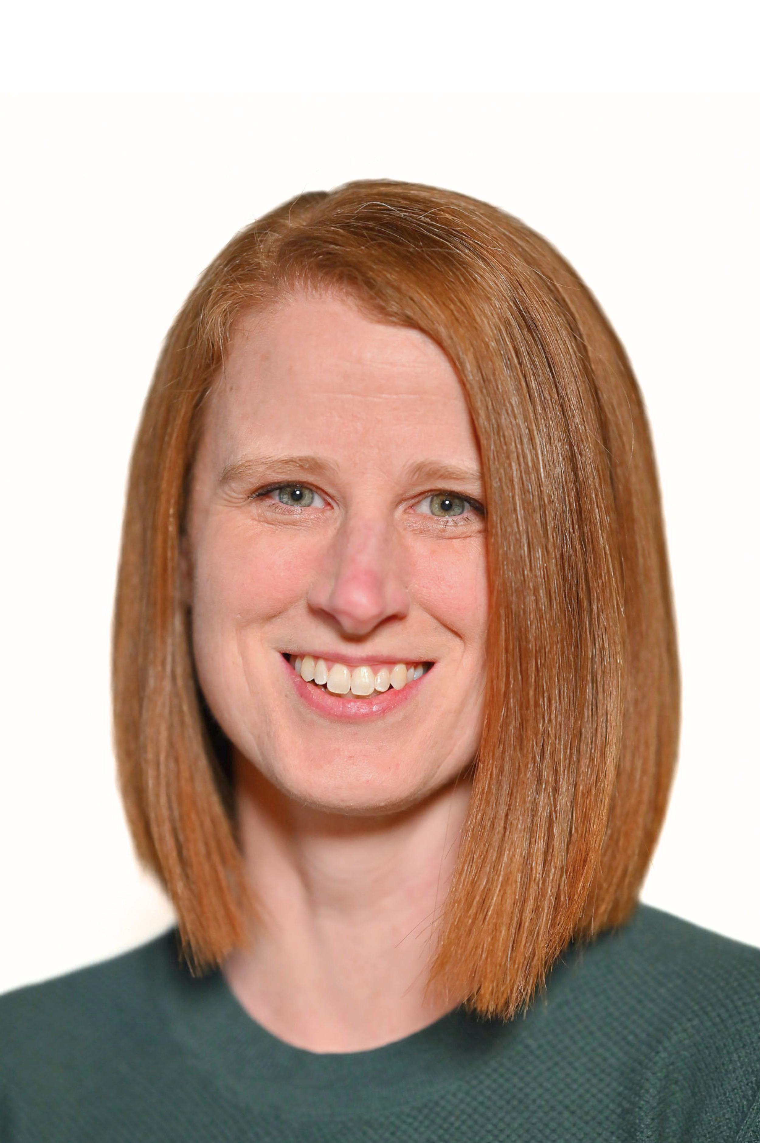A woman with straight, shoulder-length hair smiling in a portrait photo.