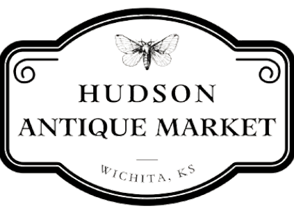 Sign for Hudson Antique Market in Wichita, Kansas, with a butterfly illustration at the top.