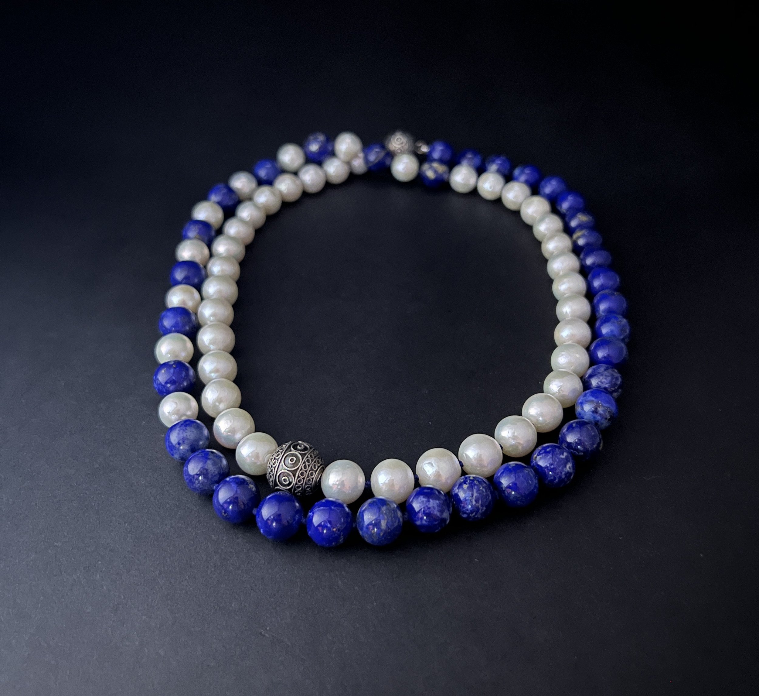 A Dance of Deep Blue and Iridescent White, Framed in Silver