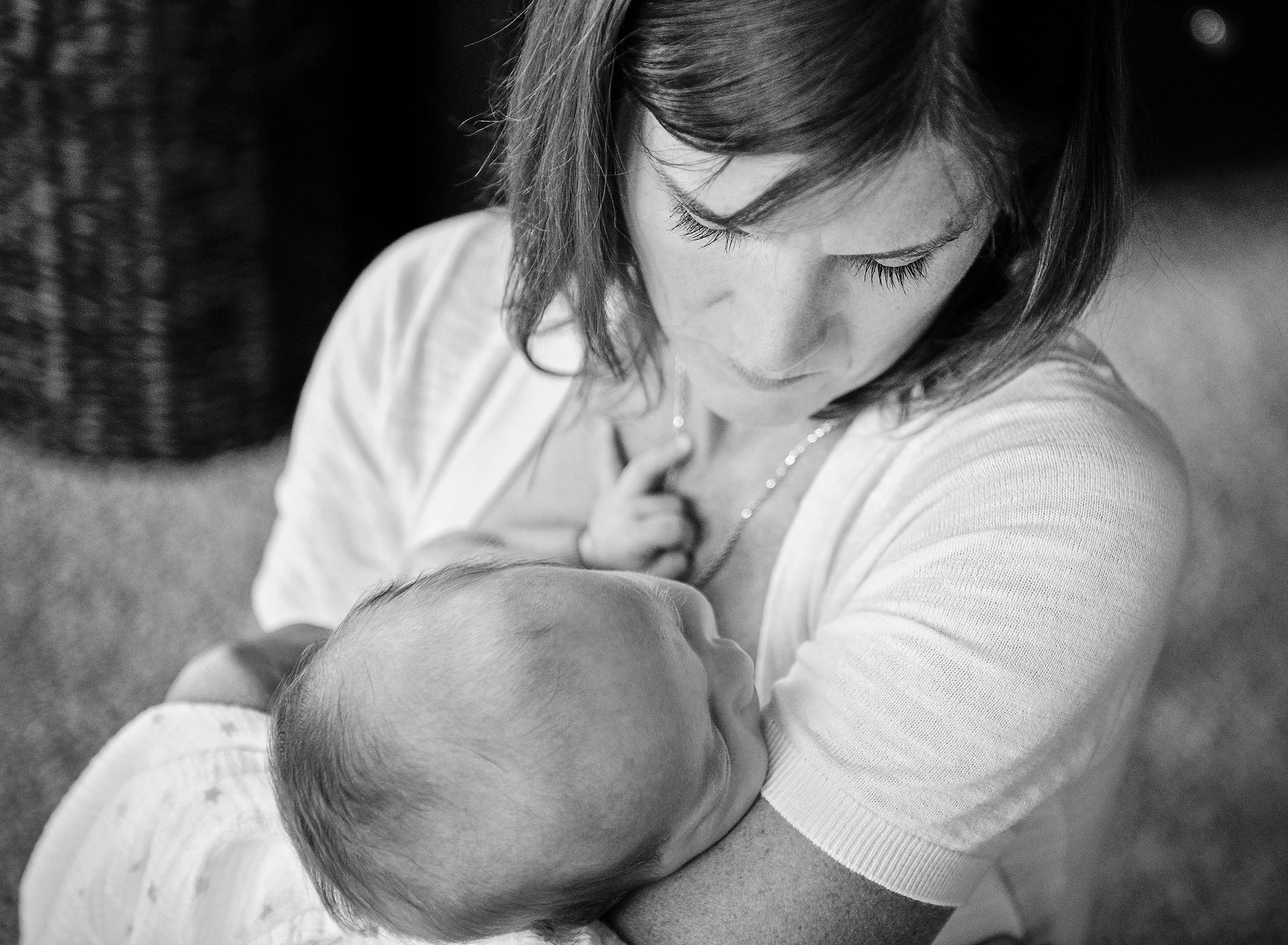 Woman holding a sleeping newborn baby