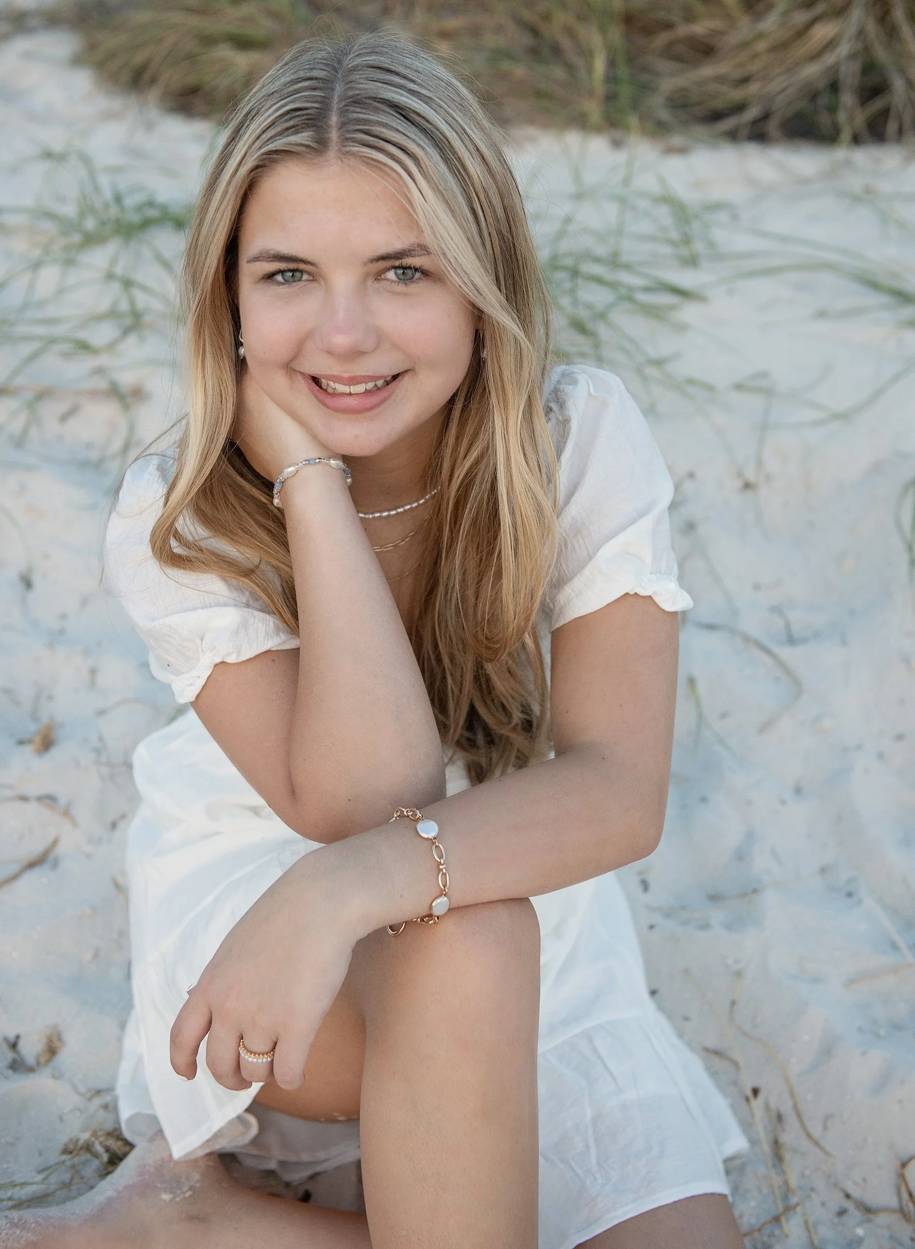Teen girl sitting on a beach at Cypress Point Park in Tampa