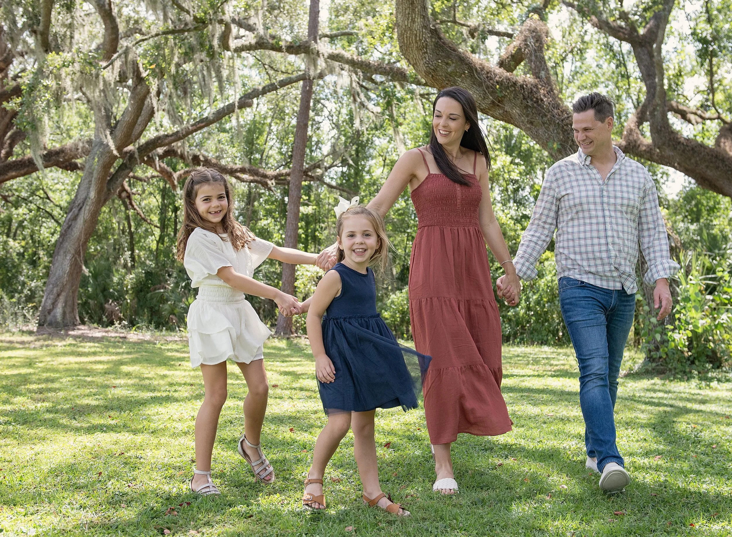 Family holding hands and laughing at a holiday mini session in Tampa