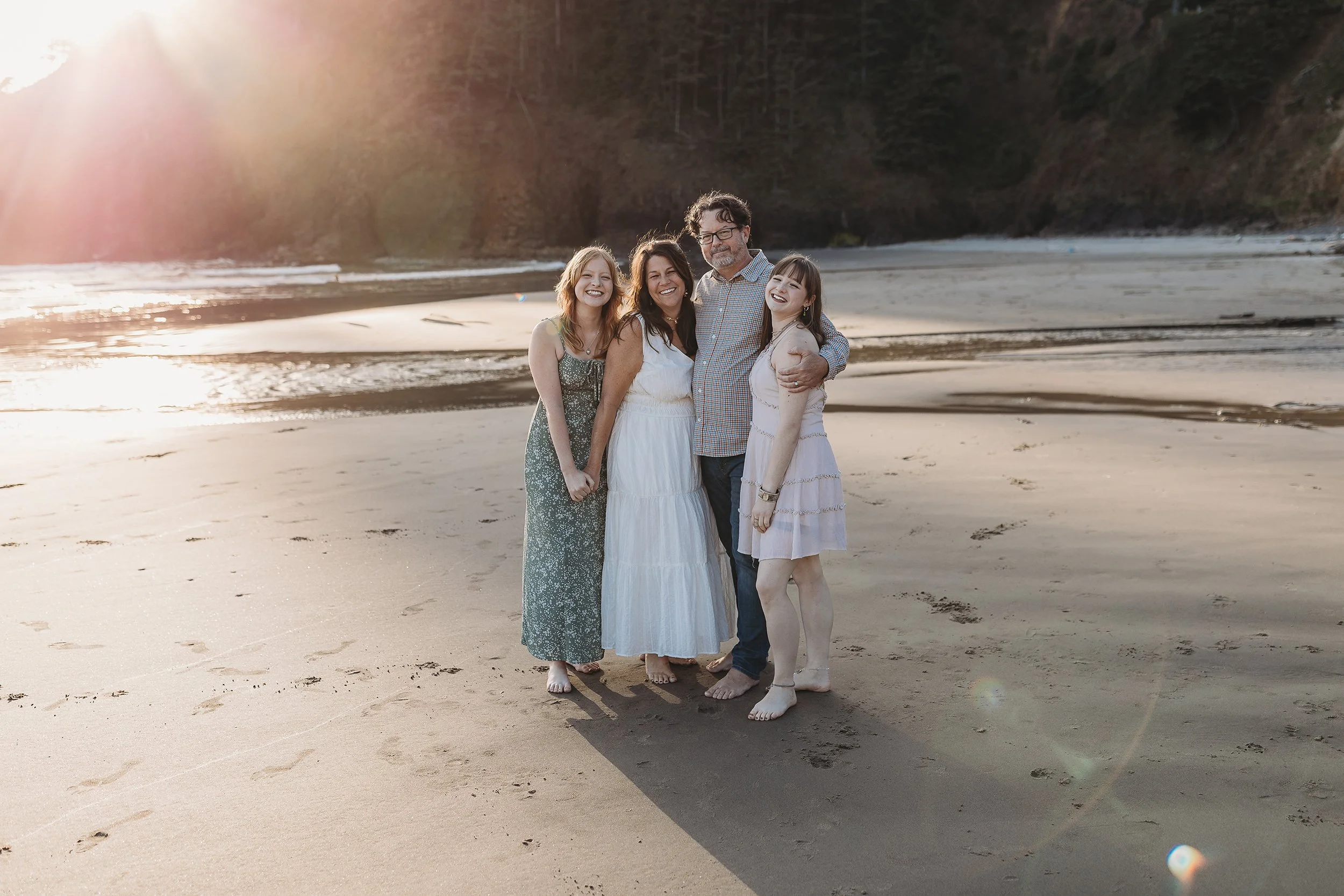 Family portrait session on a beach at sunset