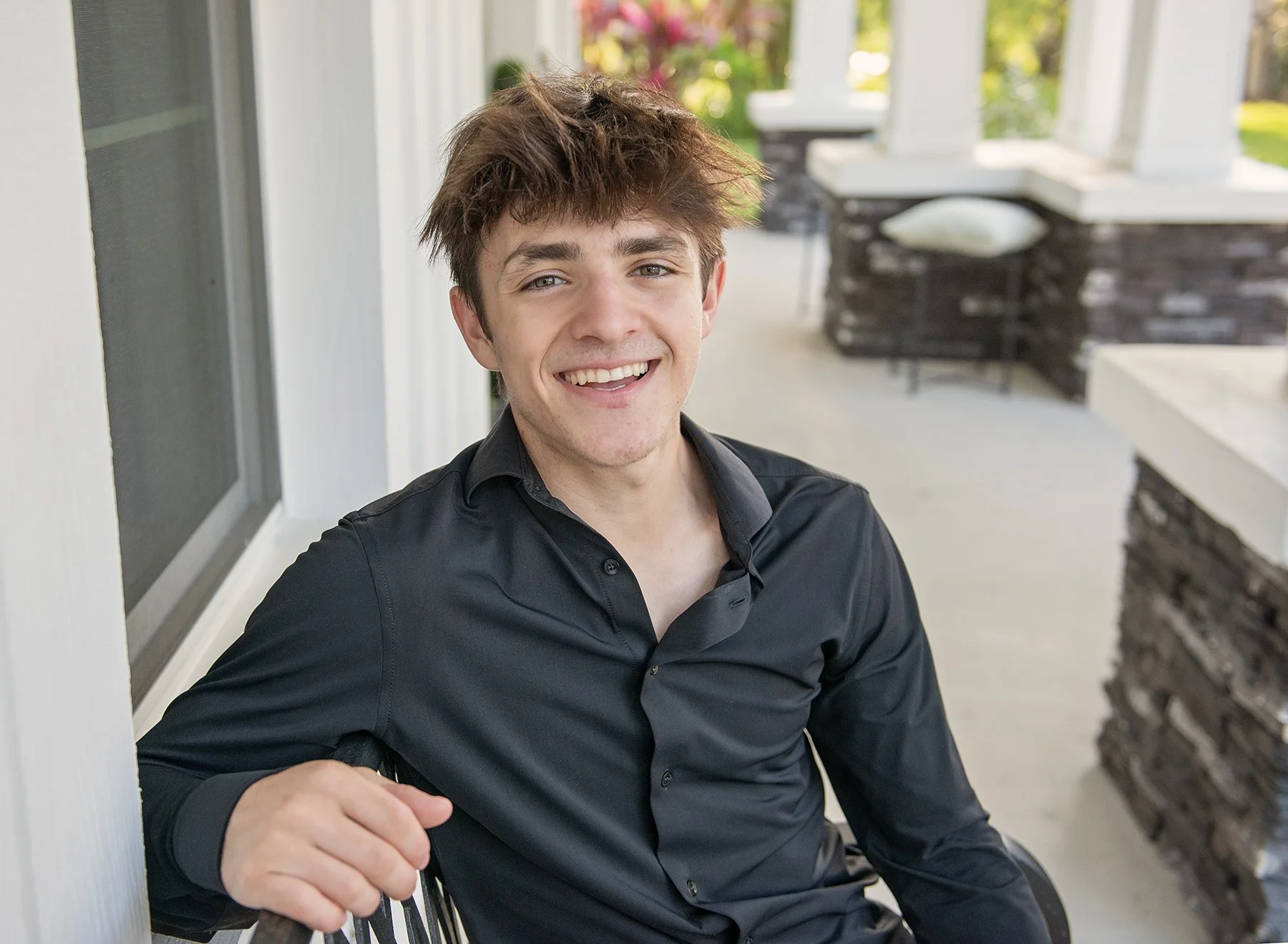 Teen boy sitting on a porch in Brandon