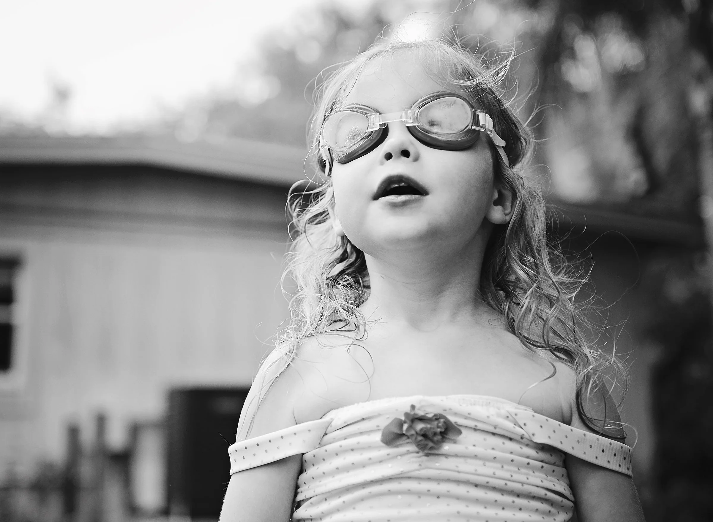 Toddler wearing goggles and a bathing suit