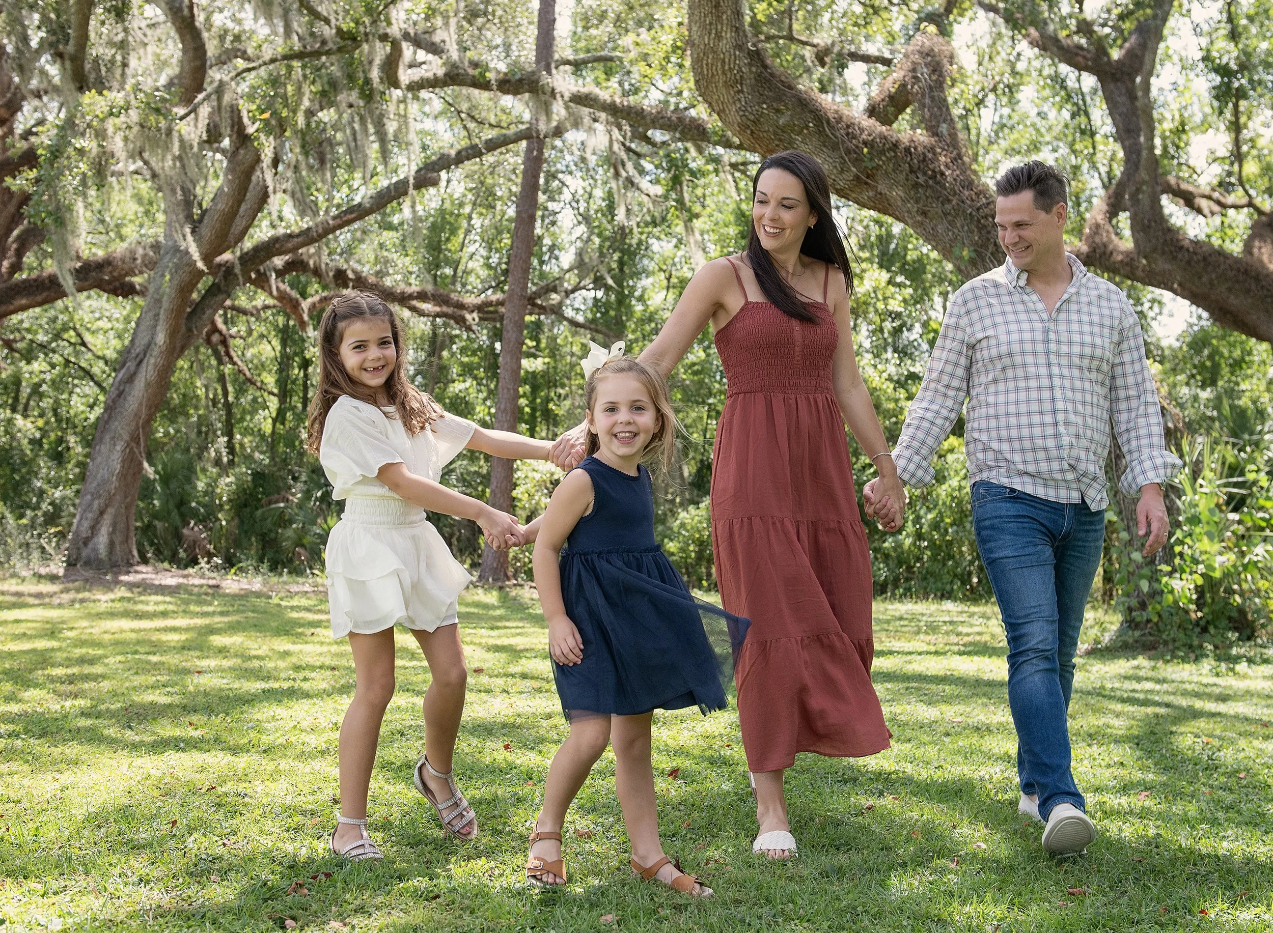 Family walking in a sunny greenspace in Tampa