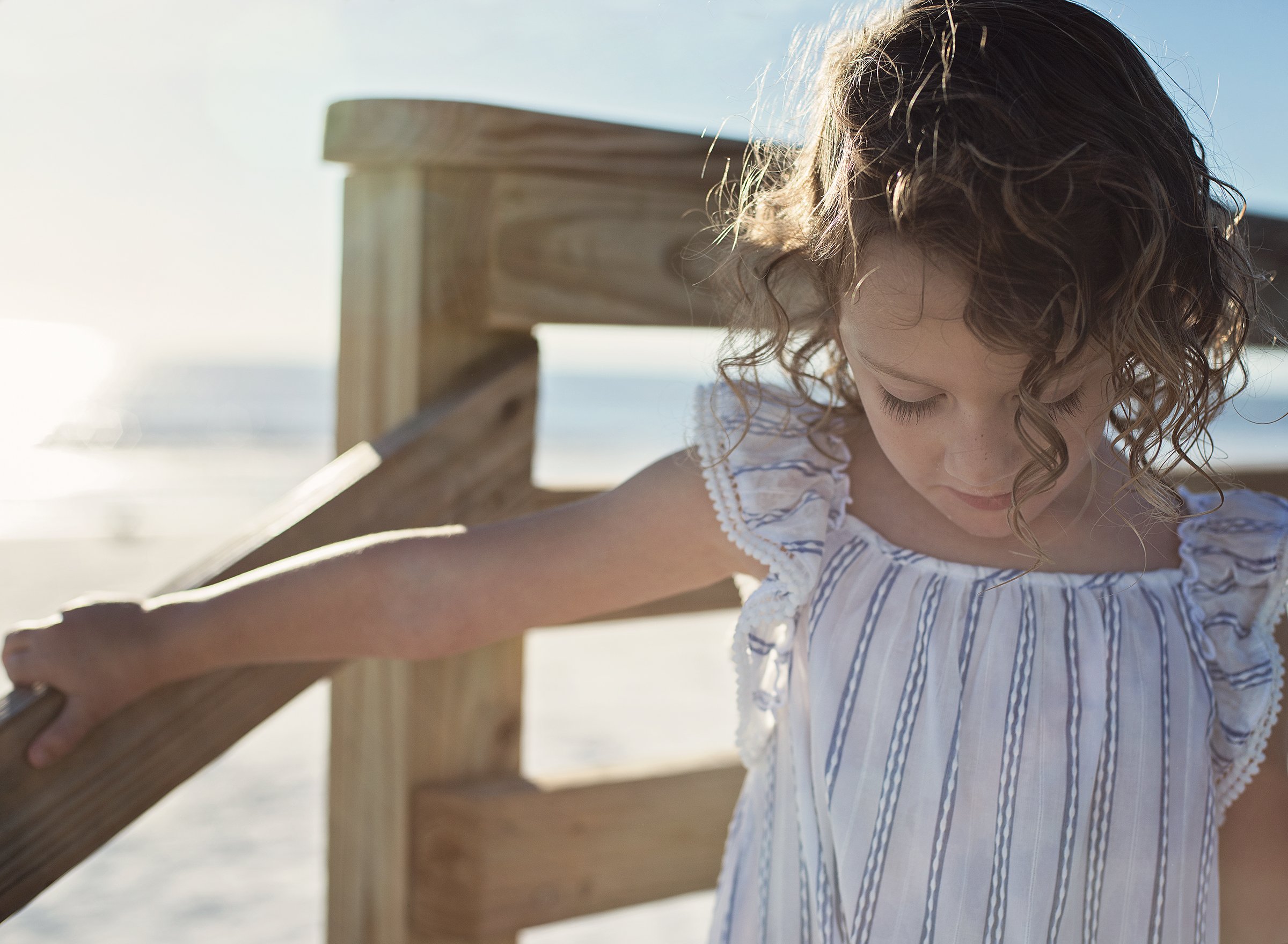 Young girl on a boardwalk at sunset at Honeymoon Island State Park
