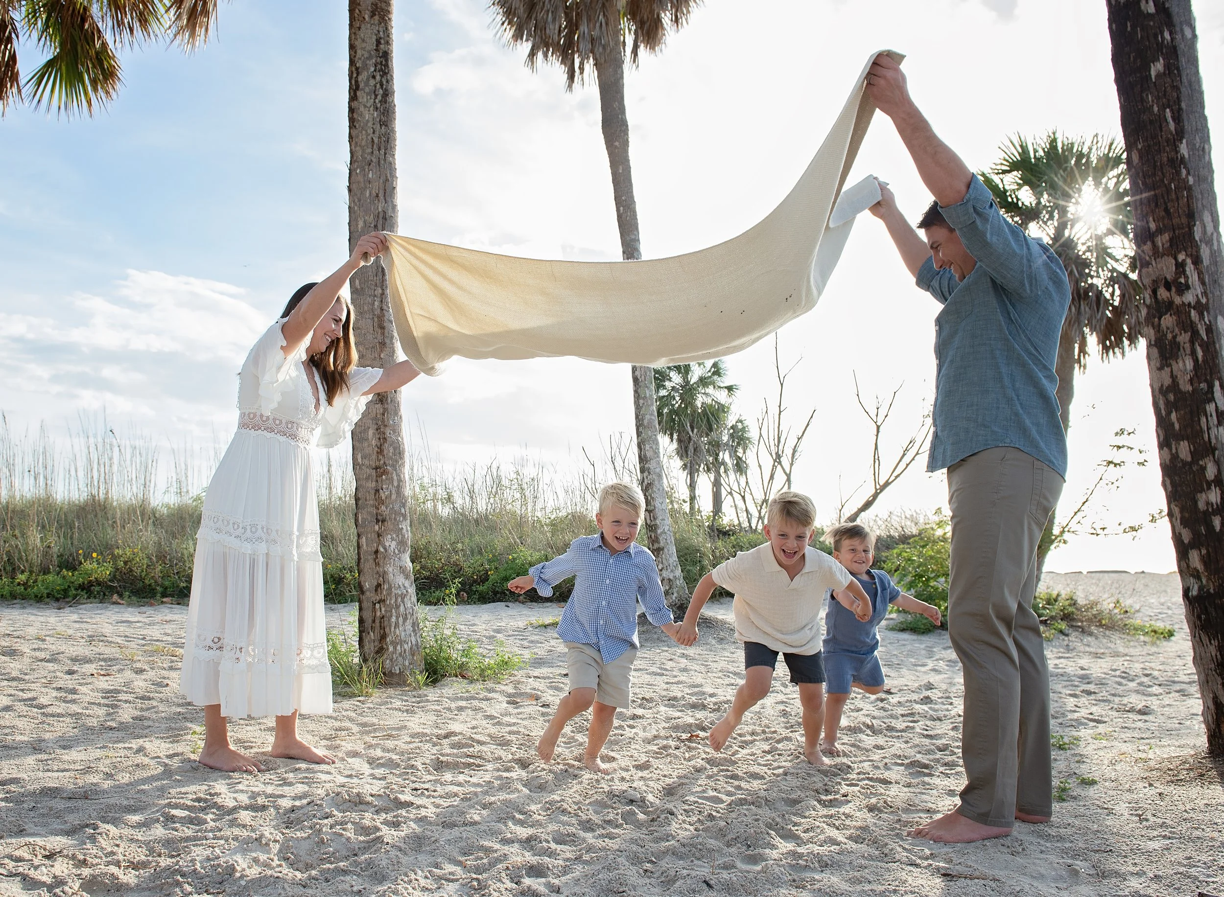 Family laughing at a Tampa-area beach in a blog about best locations for family photos